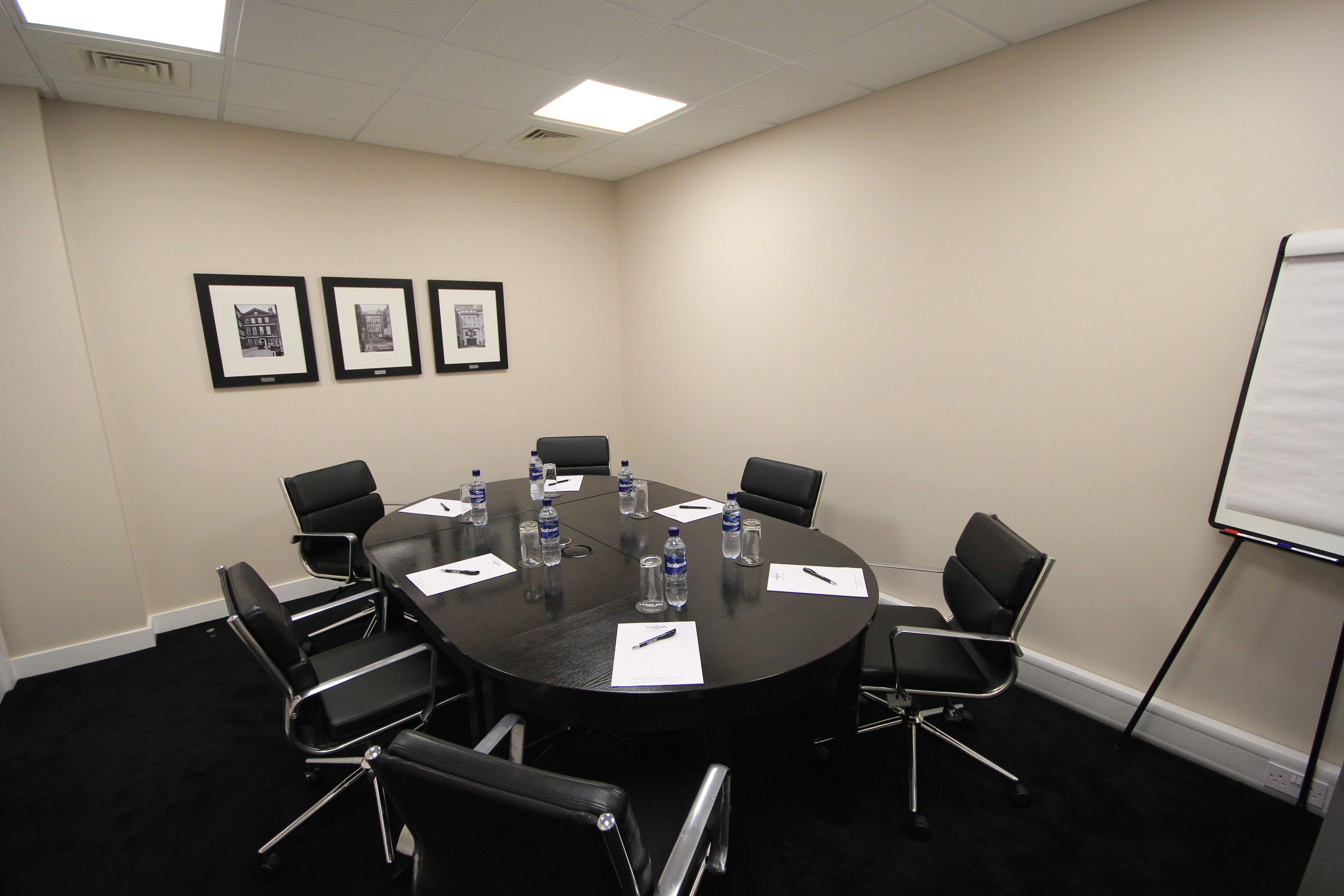 Modern Nadler Soho Boardroom with round table for meetings and workshops.