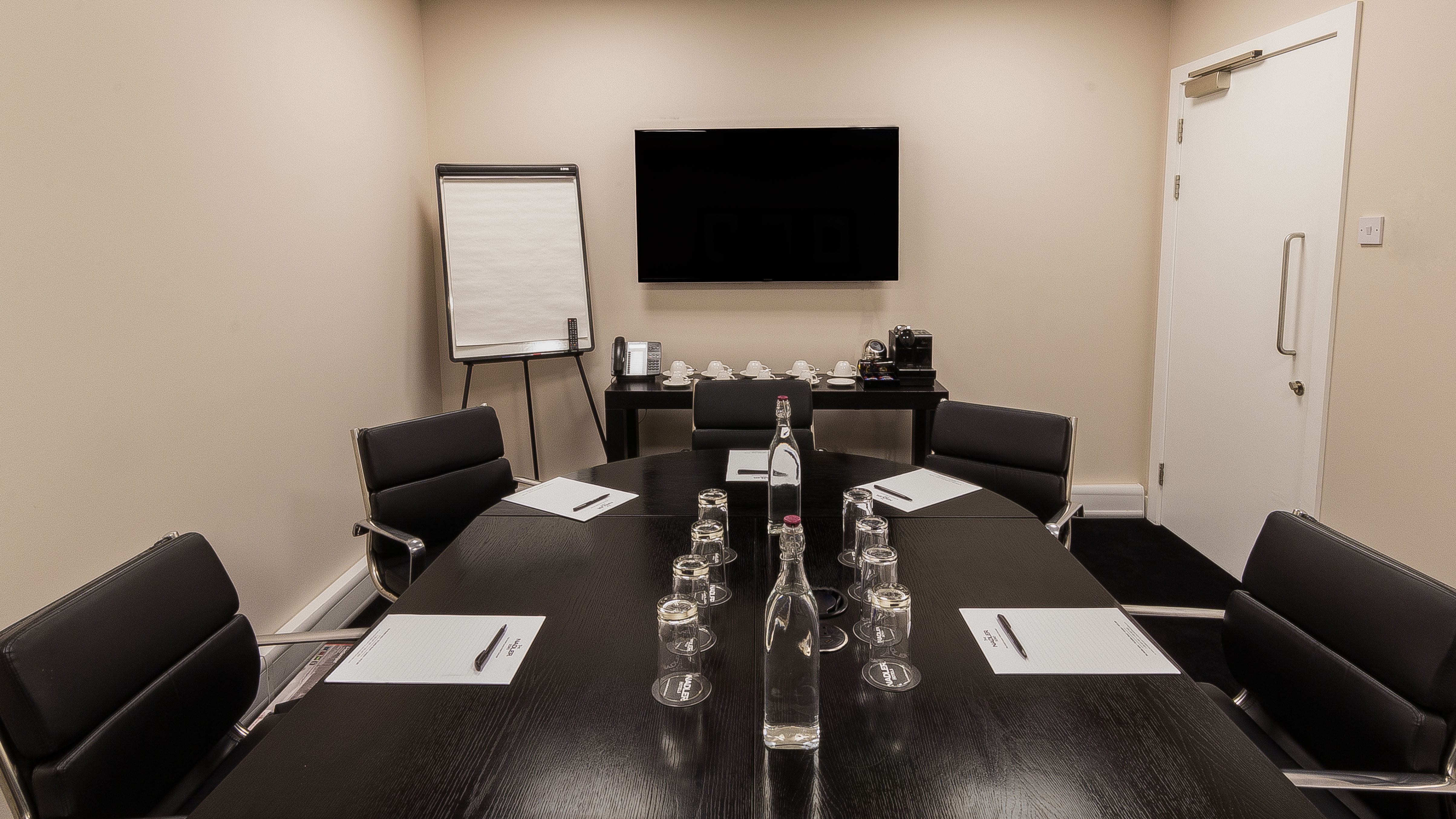 Nadler Soho Boardroom with sleek table, ideal for professional meetings and presentations.