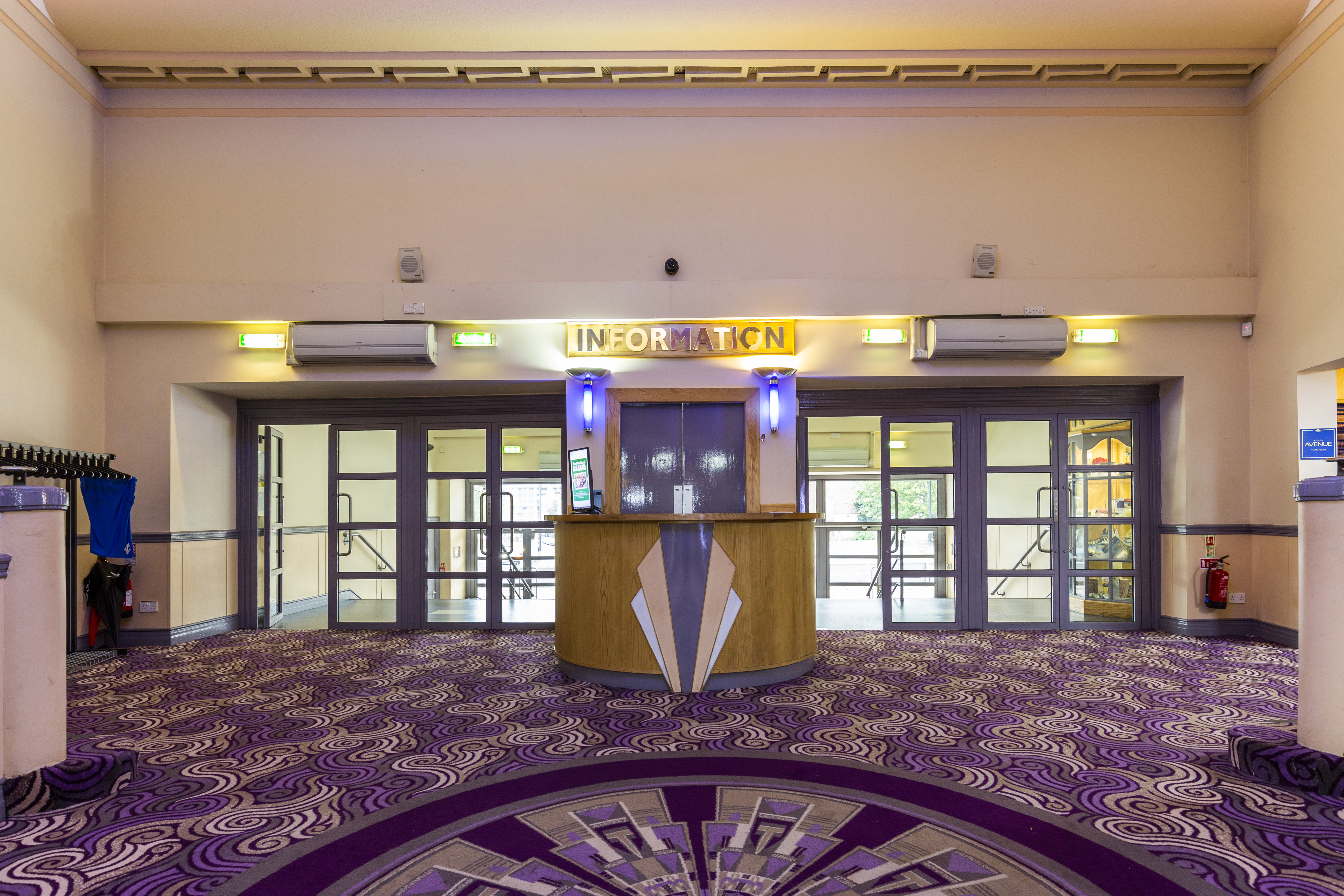 Spacious event reception area with elegant carpet and information desk at Gateway House.