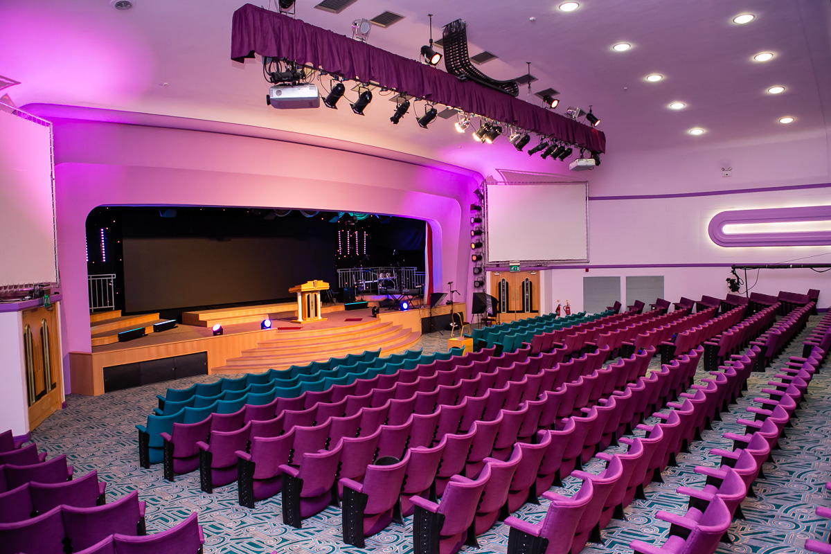 Event space with tiered seating and stage, perfect for presentations and performances.