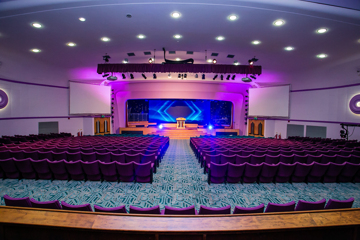 Spacious conference hall with plush seating, ideal for impactful meetings and events.