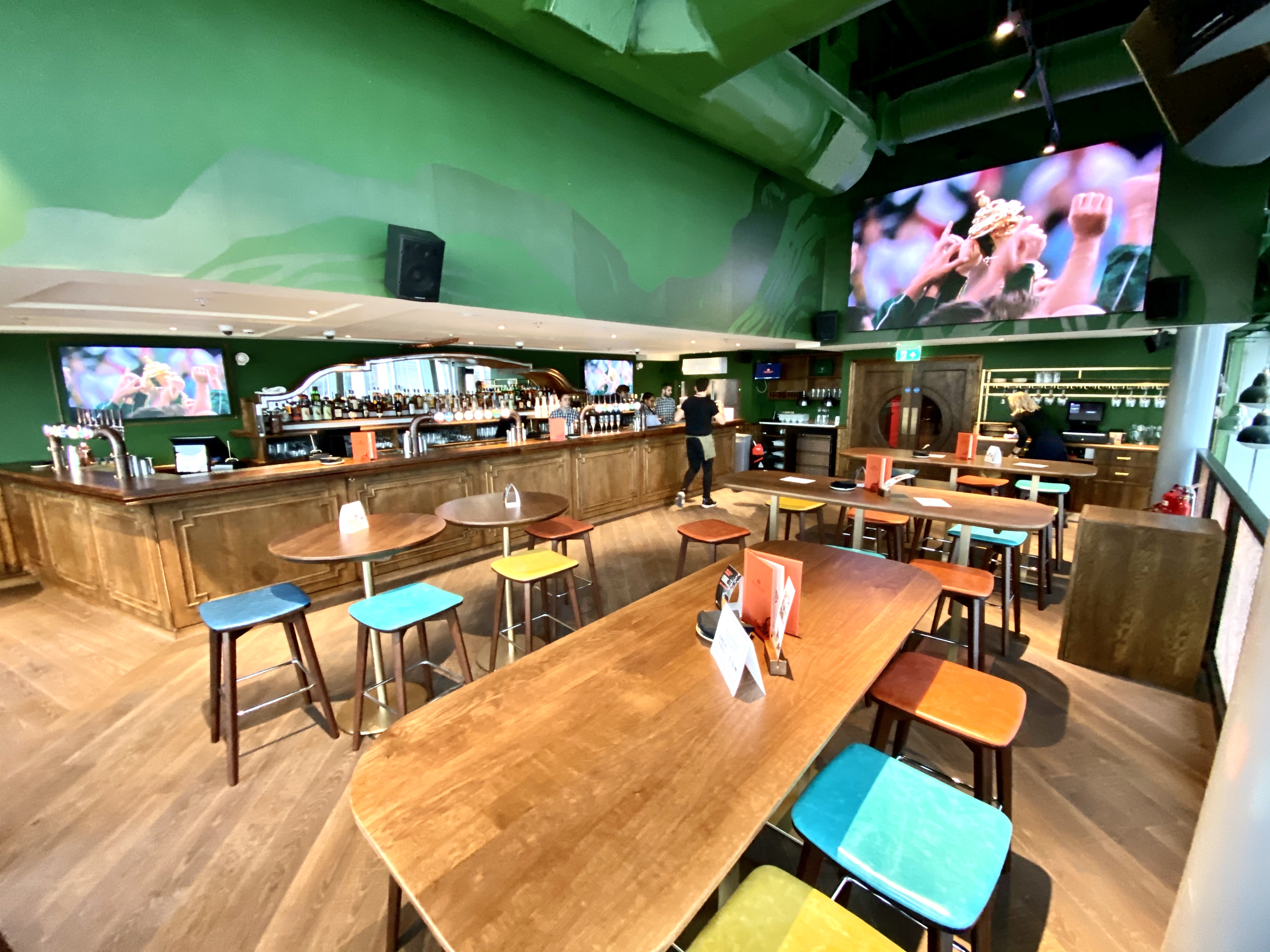 Vibrant Sports Lounge with modern bar, ideal for casual gatherings and events.