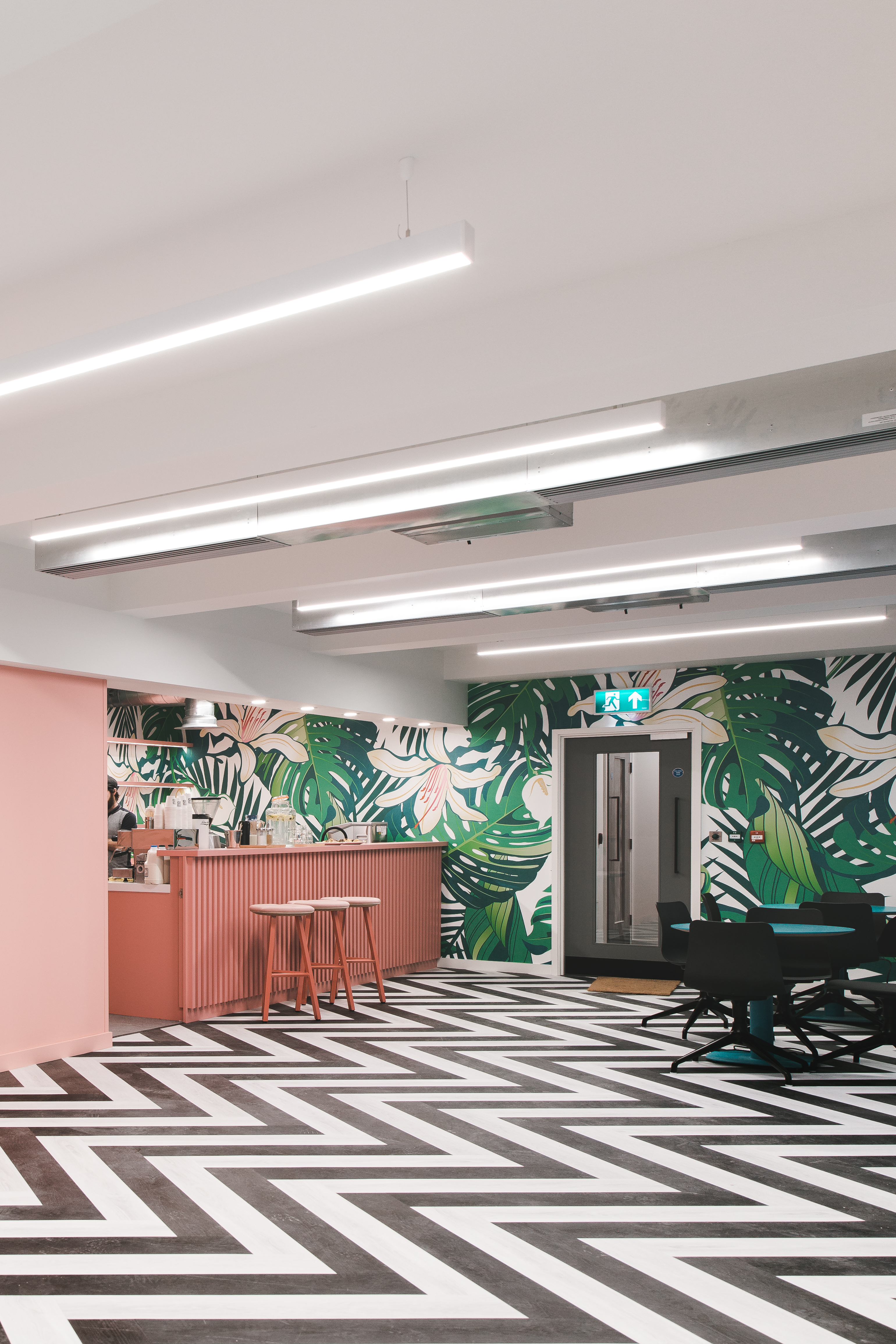 Vibrant meeting space with tropical mural for team-building and networking events.