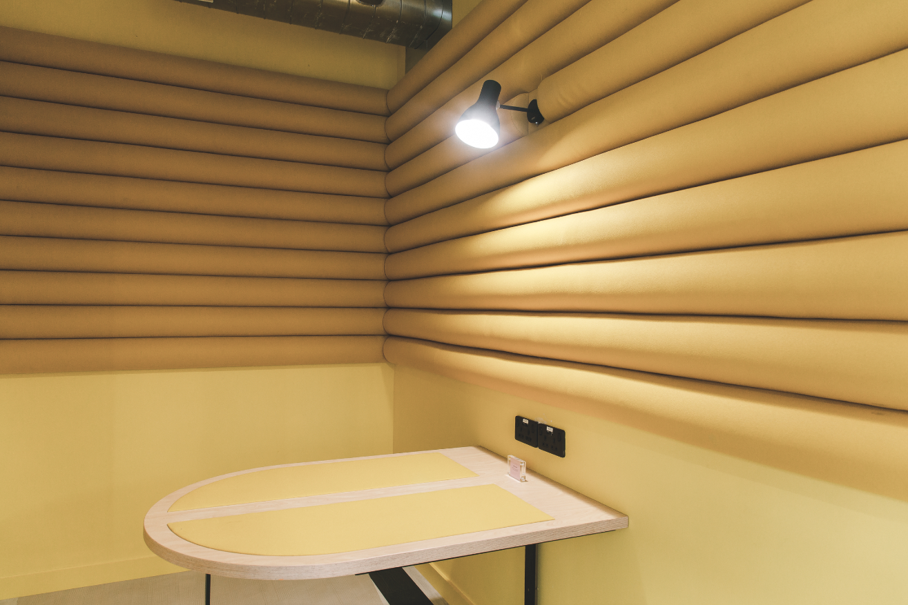 Podcast studio with padded walls, warm tones for intimate discussions in Huckletree Ancoats.