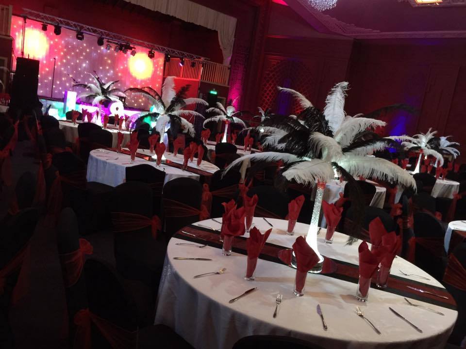 Elegant event space at Burton Ritz with feather centerpieces for upscale gala.