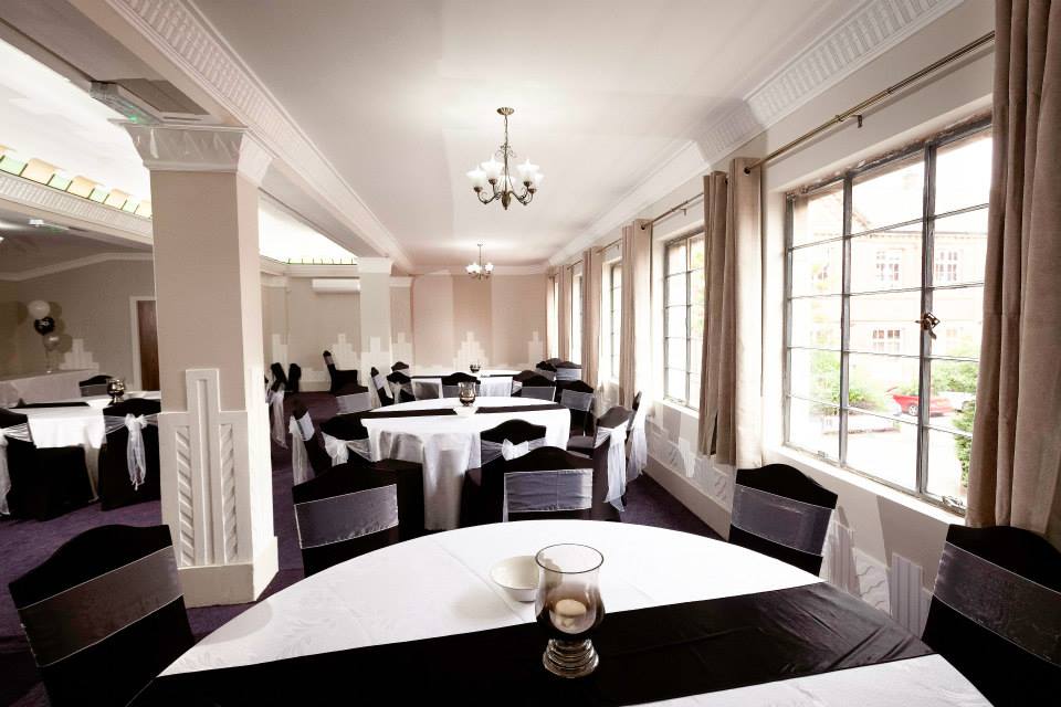 Elegant meeting room at Burton Ritz with round tables, ideal for corporate events.