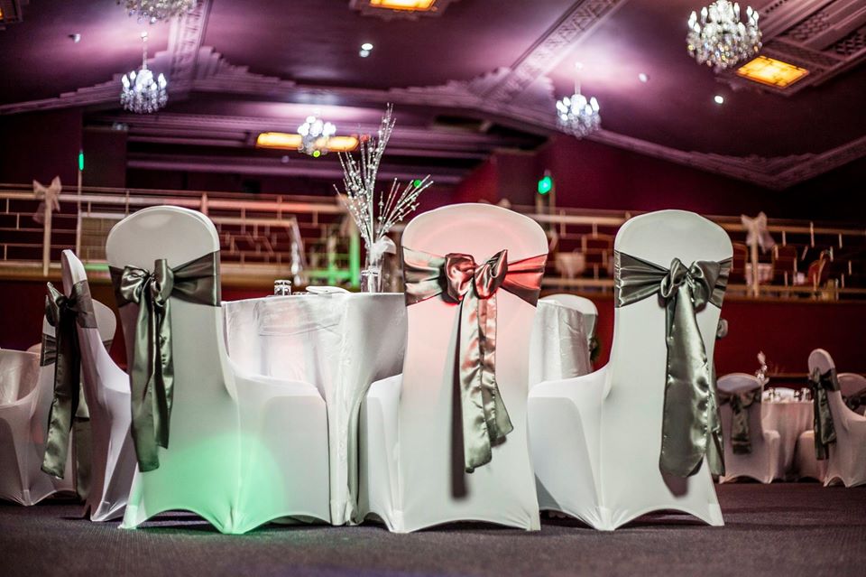 Elegant event space at Burton Ritz with satin bow chairs, perfect for weddings and corporate events.