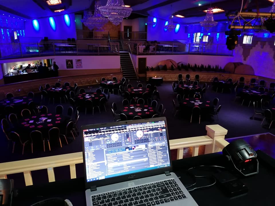 Spacious Burton Ritz venue with round tables, perfect for conferences and celebrations.