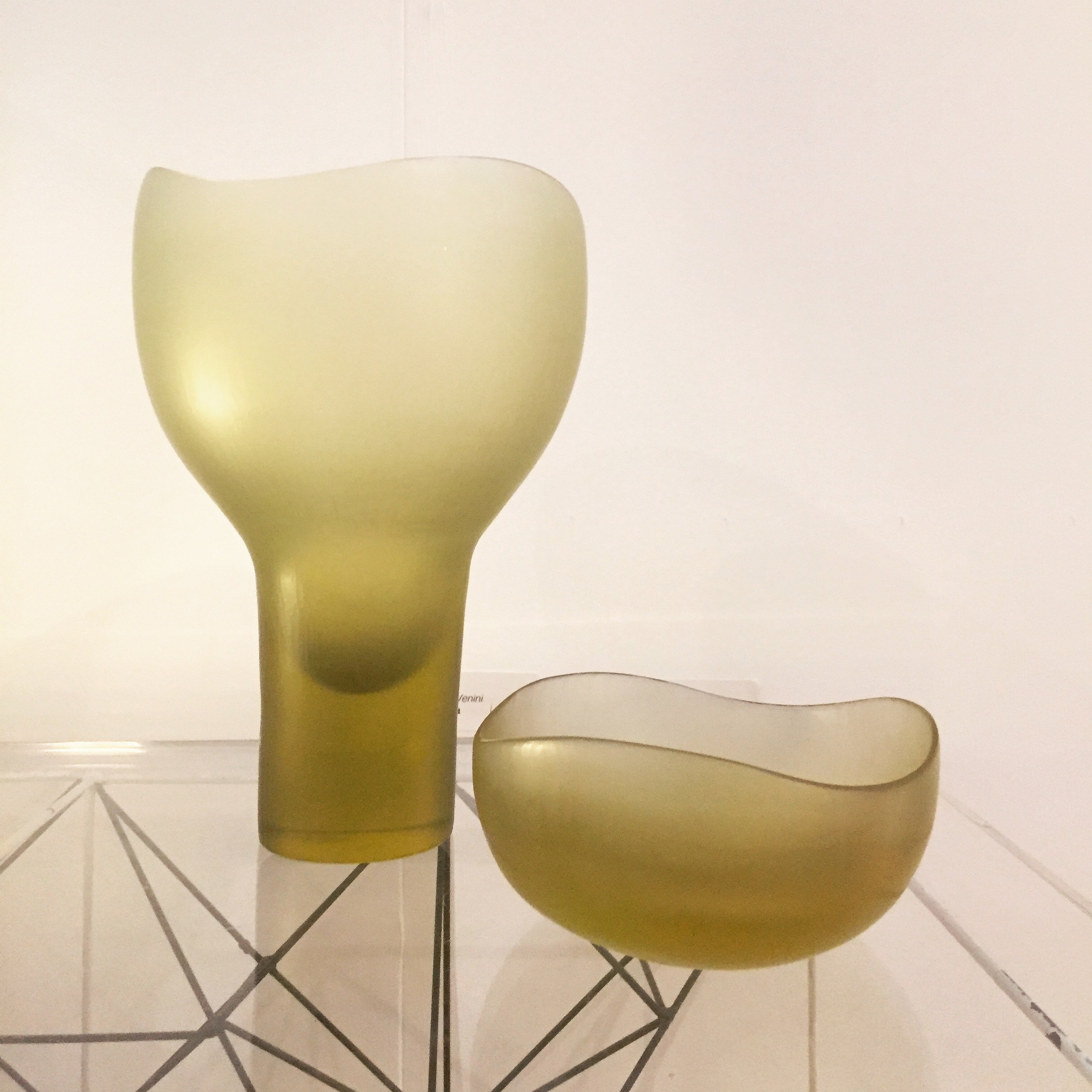 Sleek green glass vase and bowl centerpiece for upscale events and gatherings.