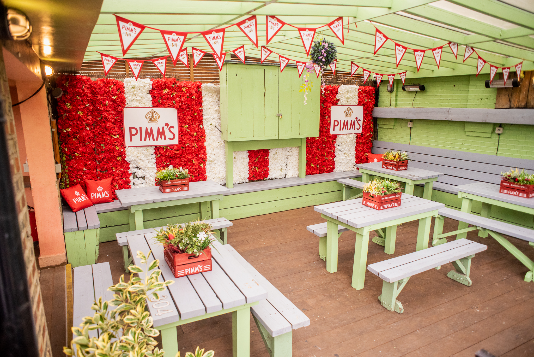 Roof Terrace at Abbey Tavern with floral backdrop, ideal for summer parties and gatherings.