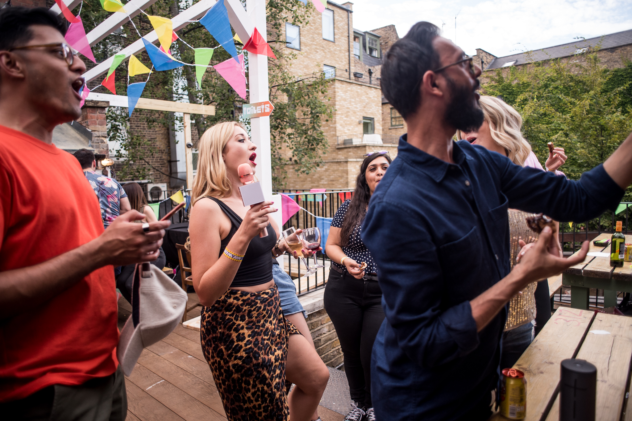 Lively outdoor team-building event at Abbey Tavern with colorful bunting and engaged attendees.