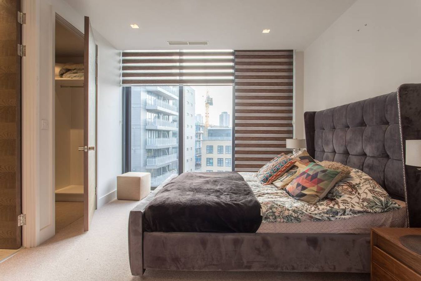 Modern penthouse venue with plush bed, ideal for filming and intimate events.