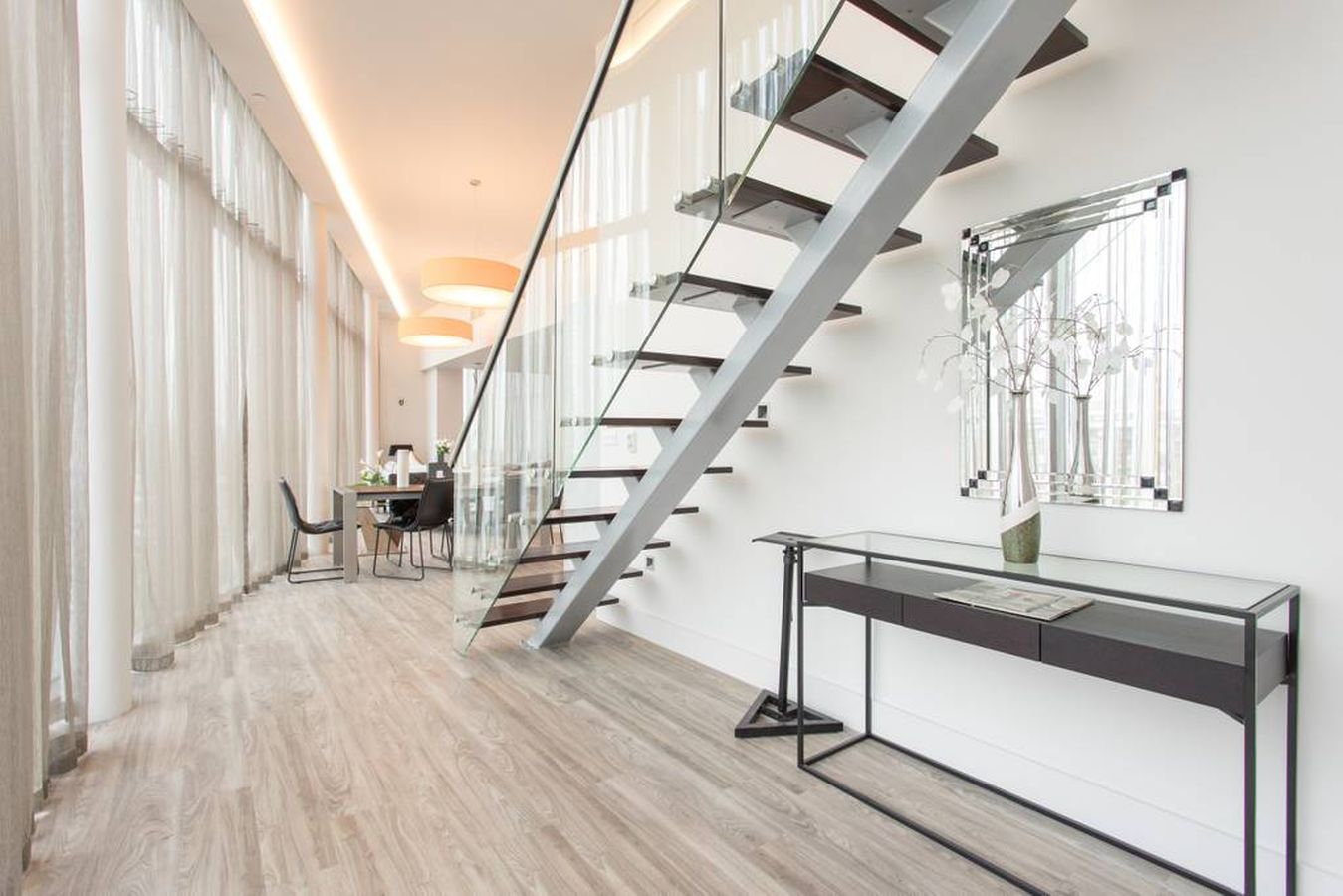 Modern penthouse venue with large windows for upscale filming and events.