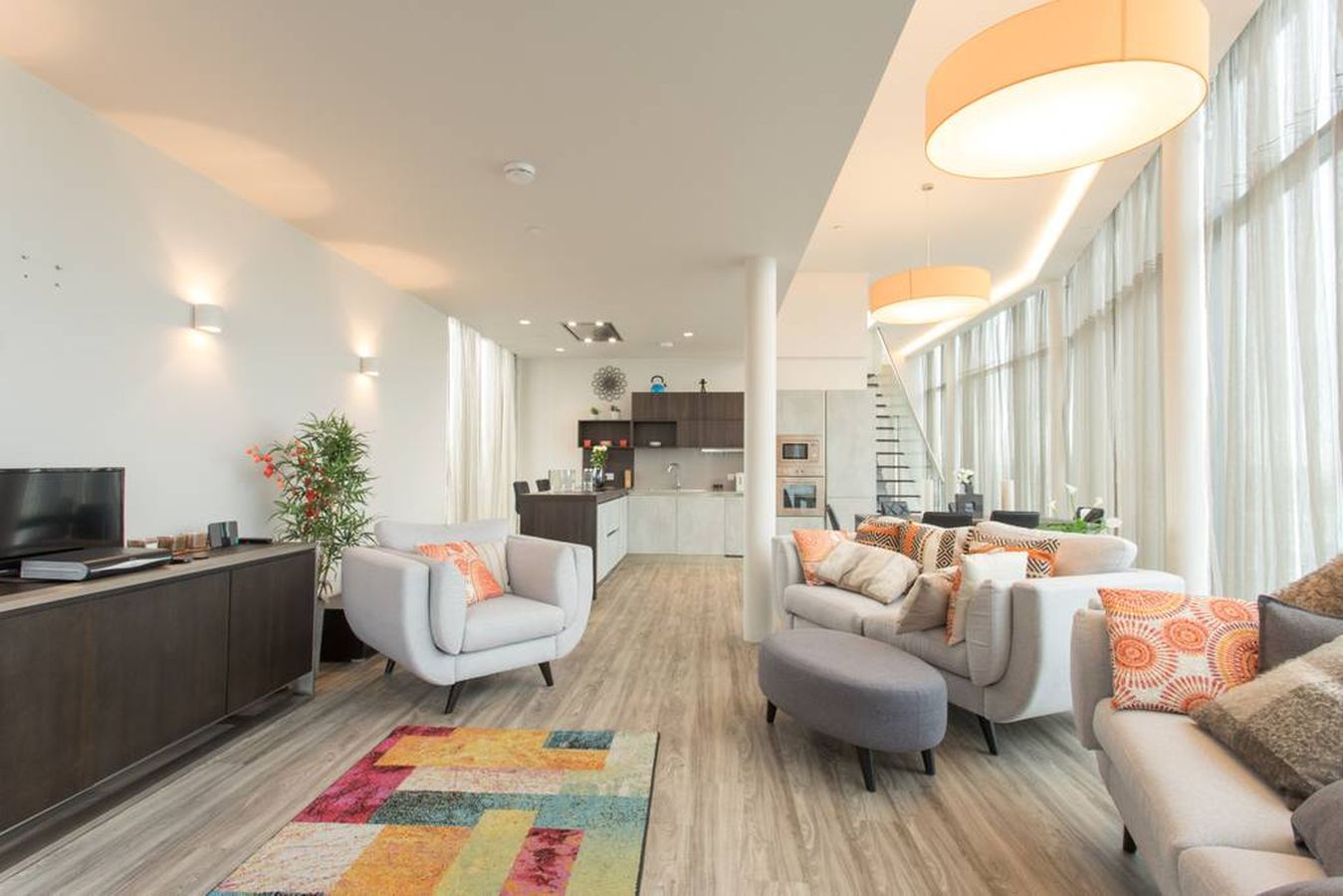 Modern penthouse lounge with large windows for filming and networking events.