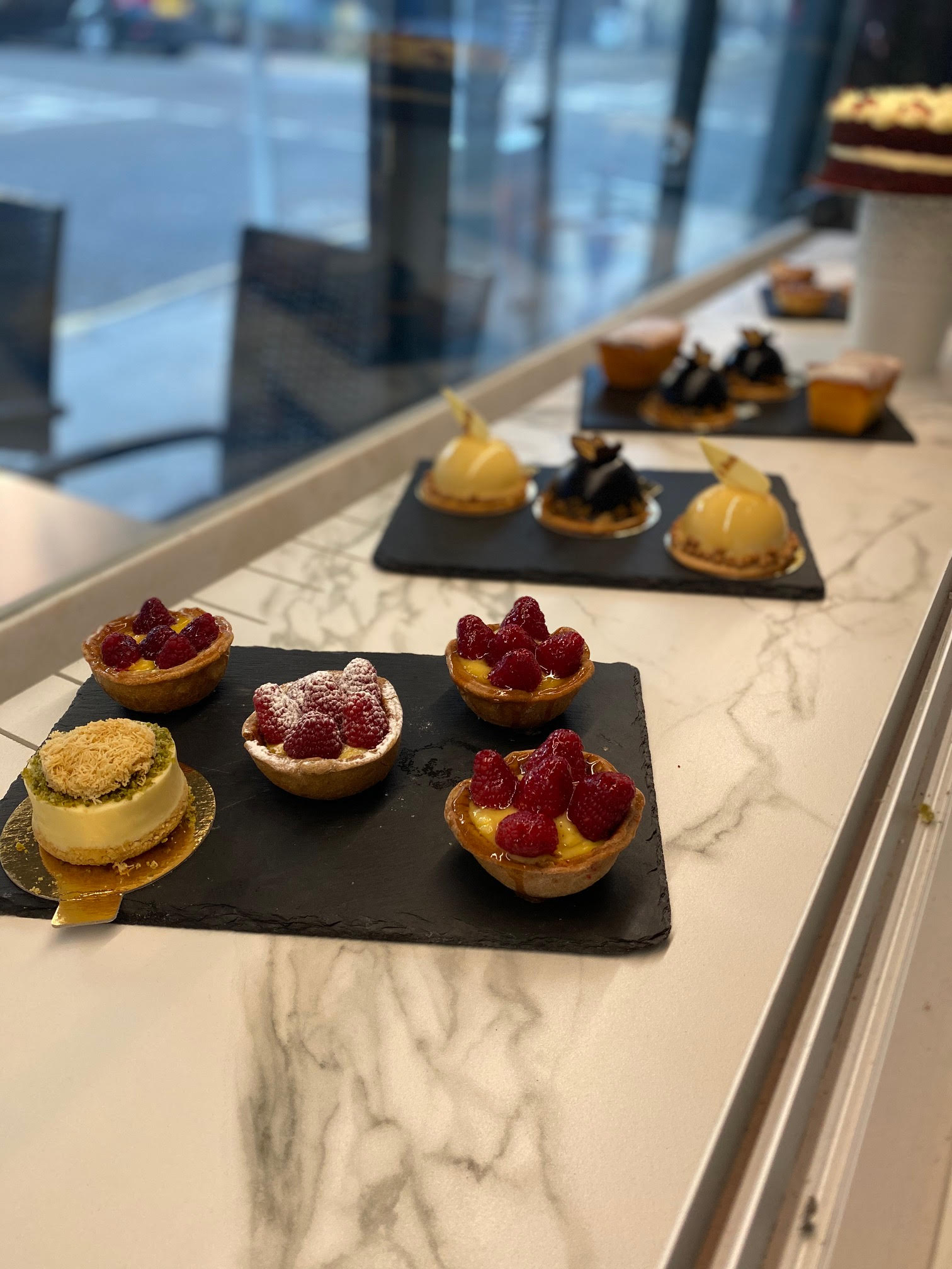 Gourmet desserts on slate boards for upscale events like galas and receptions.