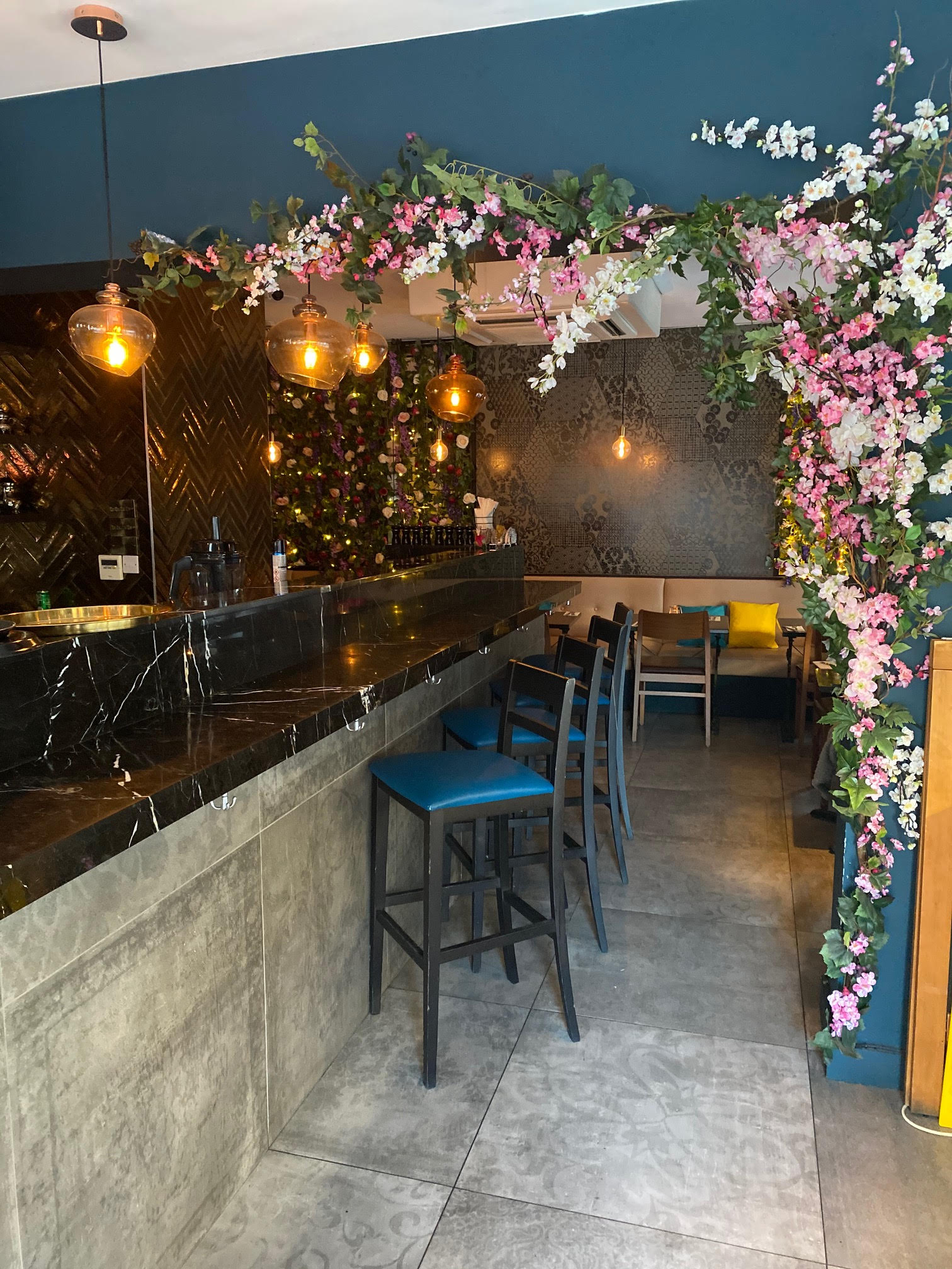 Stylish bar with floral decor, ideal for cocktail receptions and private parties.