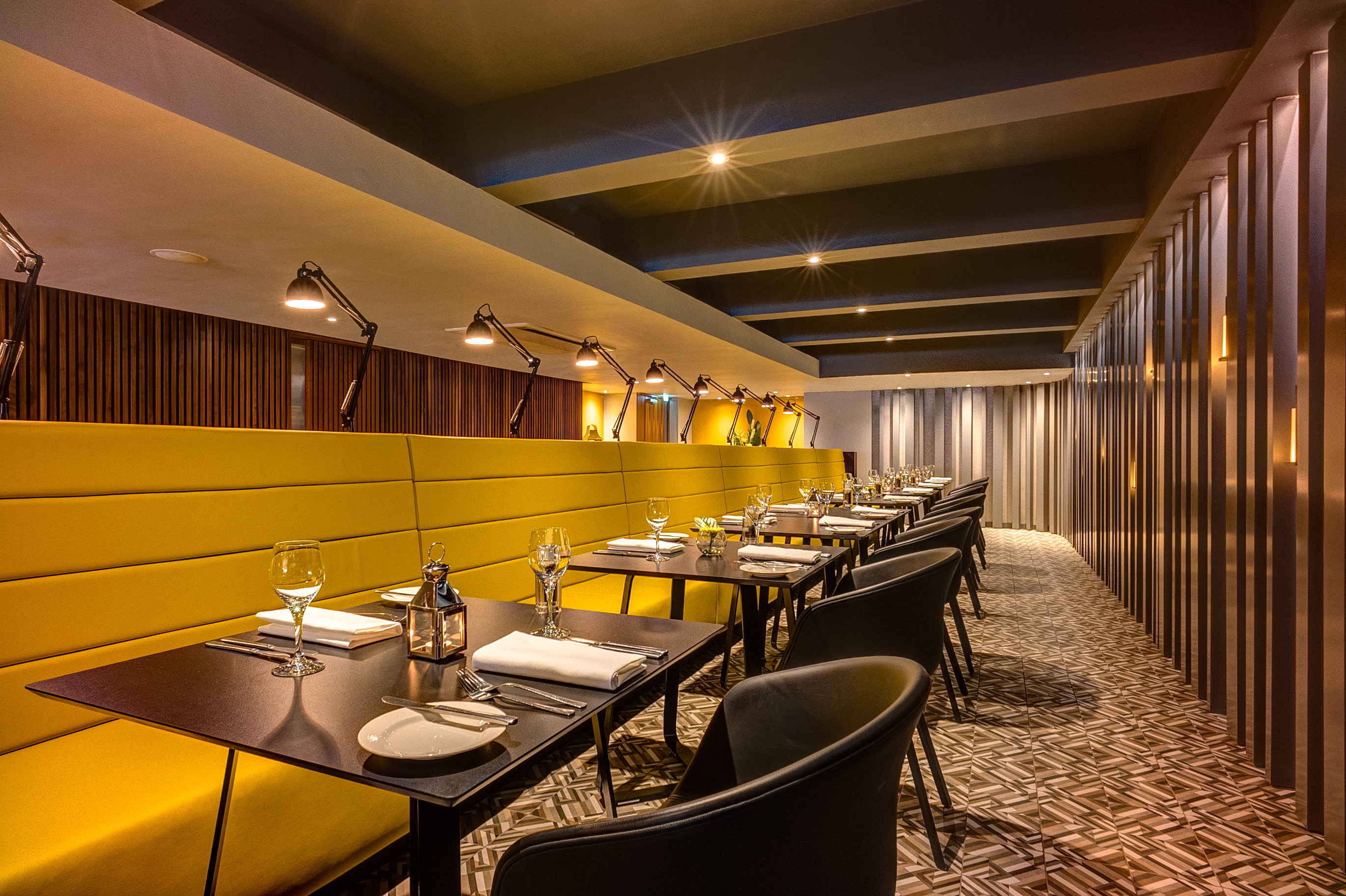 Agua Restaurant in Apex Hotel, modern dining space with warm lighting for events.
