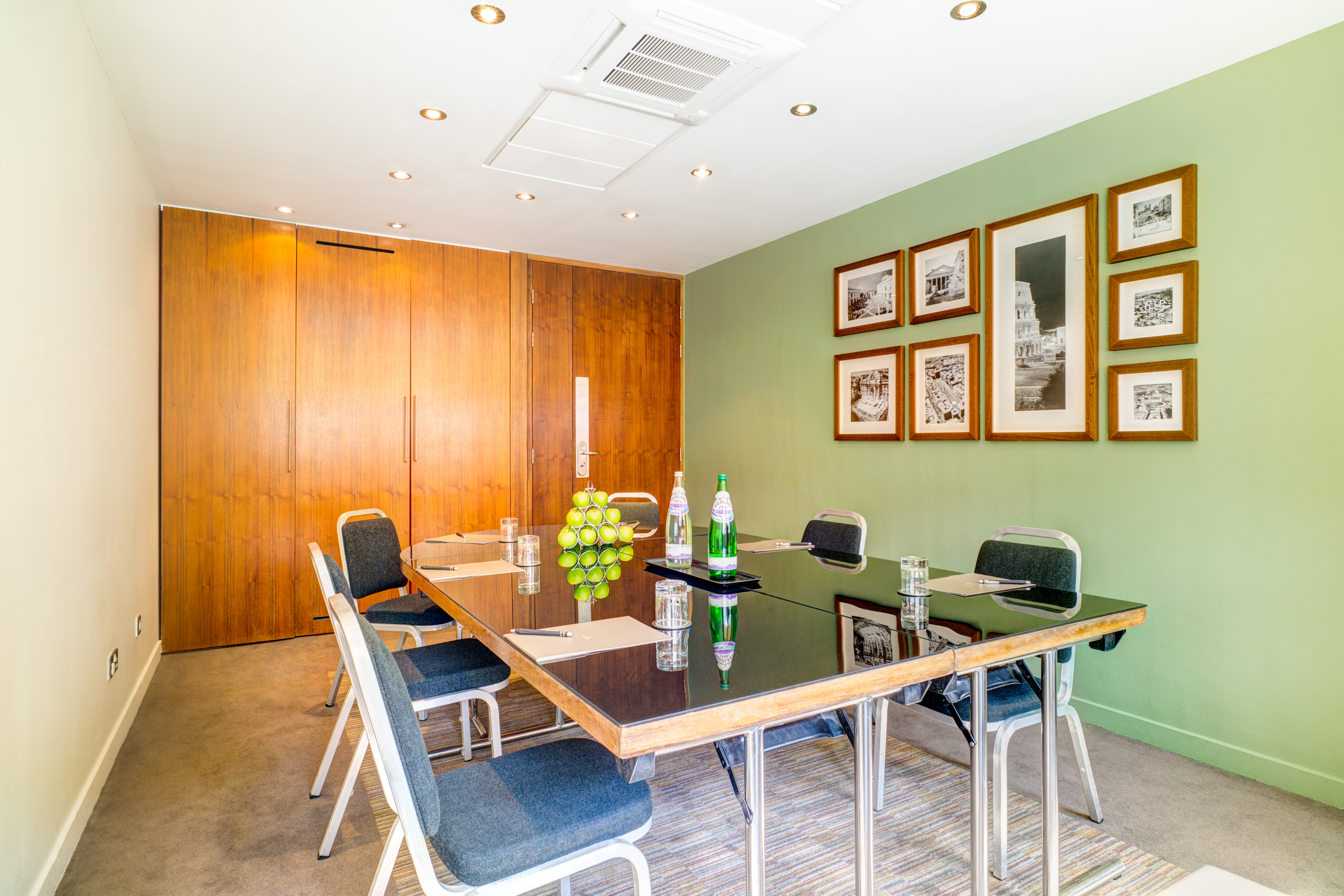 Meeting room at Apex Grassmarket Hotel, featuring a sleek wooden table for corporate events.