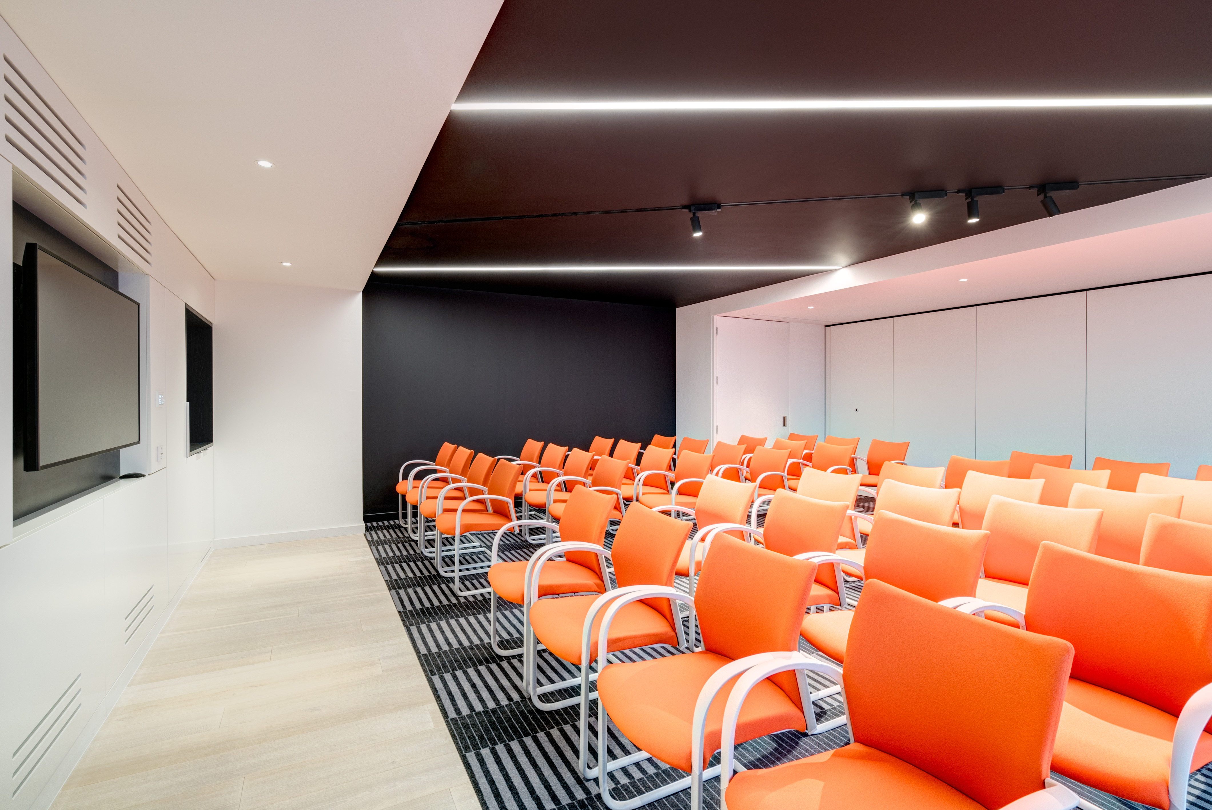 Modern meeting room at Apex City of Bath Hotel with vibrant orange seating for events.