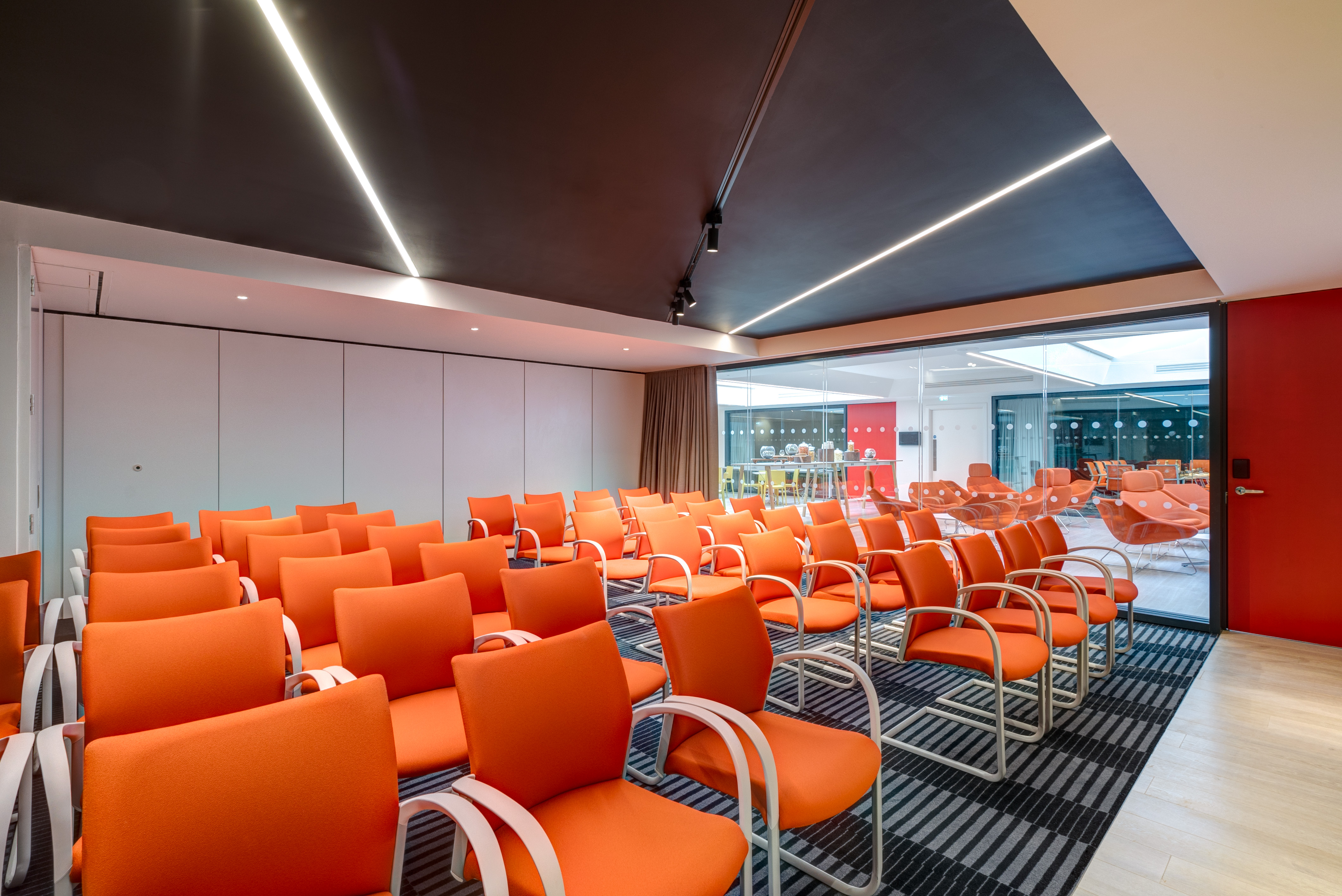 Modern meeting space at Apex City of Bath Hotel with vibrant orange chairs for workshops.