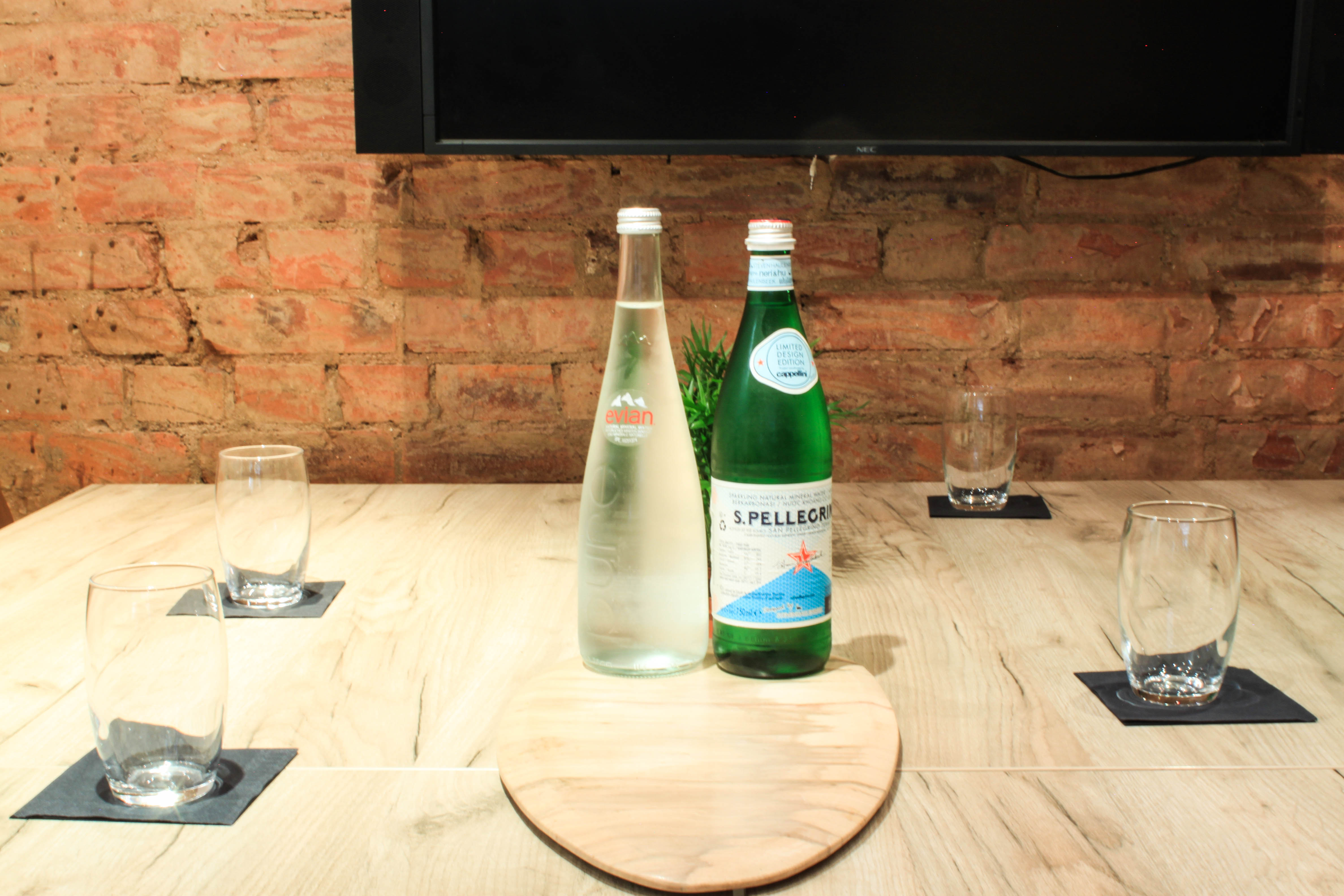 Meeting Room at The Travel Café with wooden table setup for professional events.