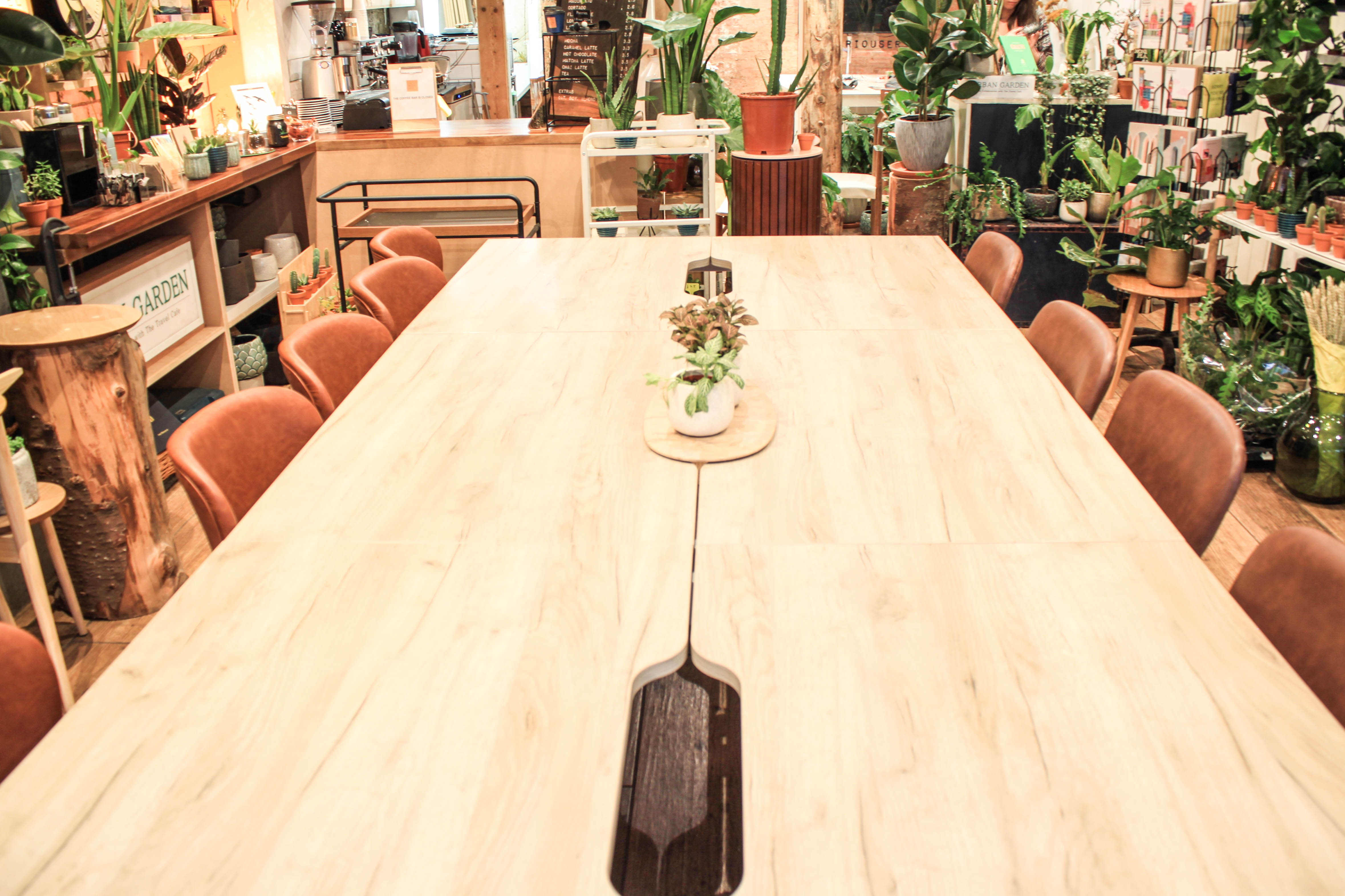 Spacious meeting room with wooden table, ideal for professional events and gatherings.