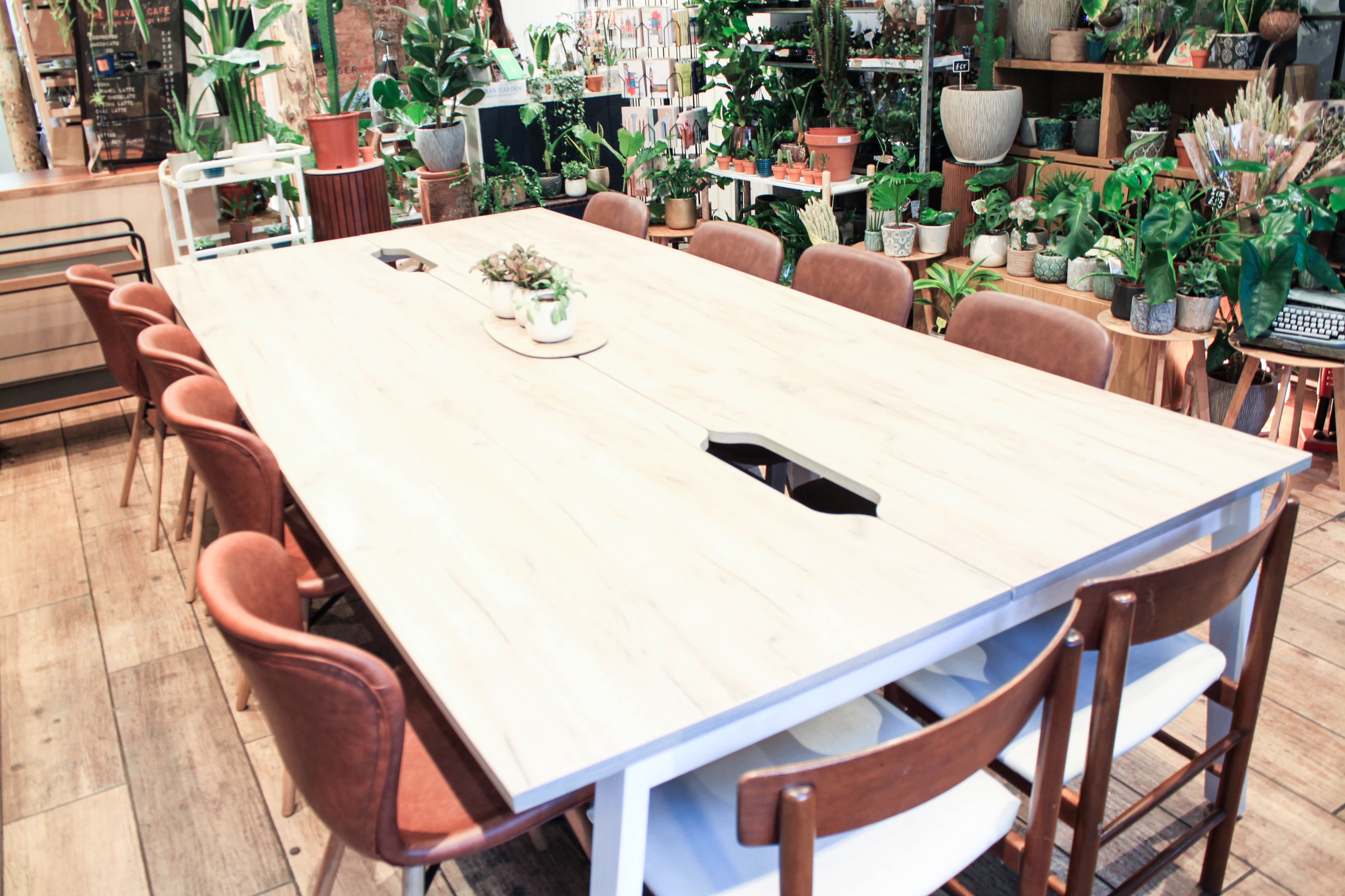 Spacious meeting room with wooden table, ideal for workshops and collaboration.
