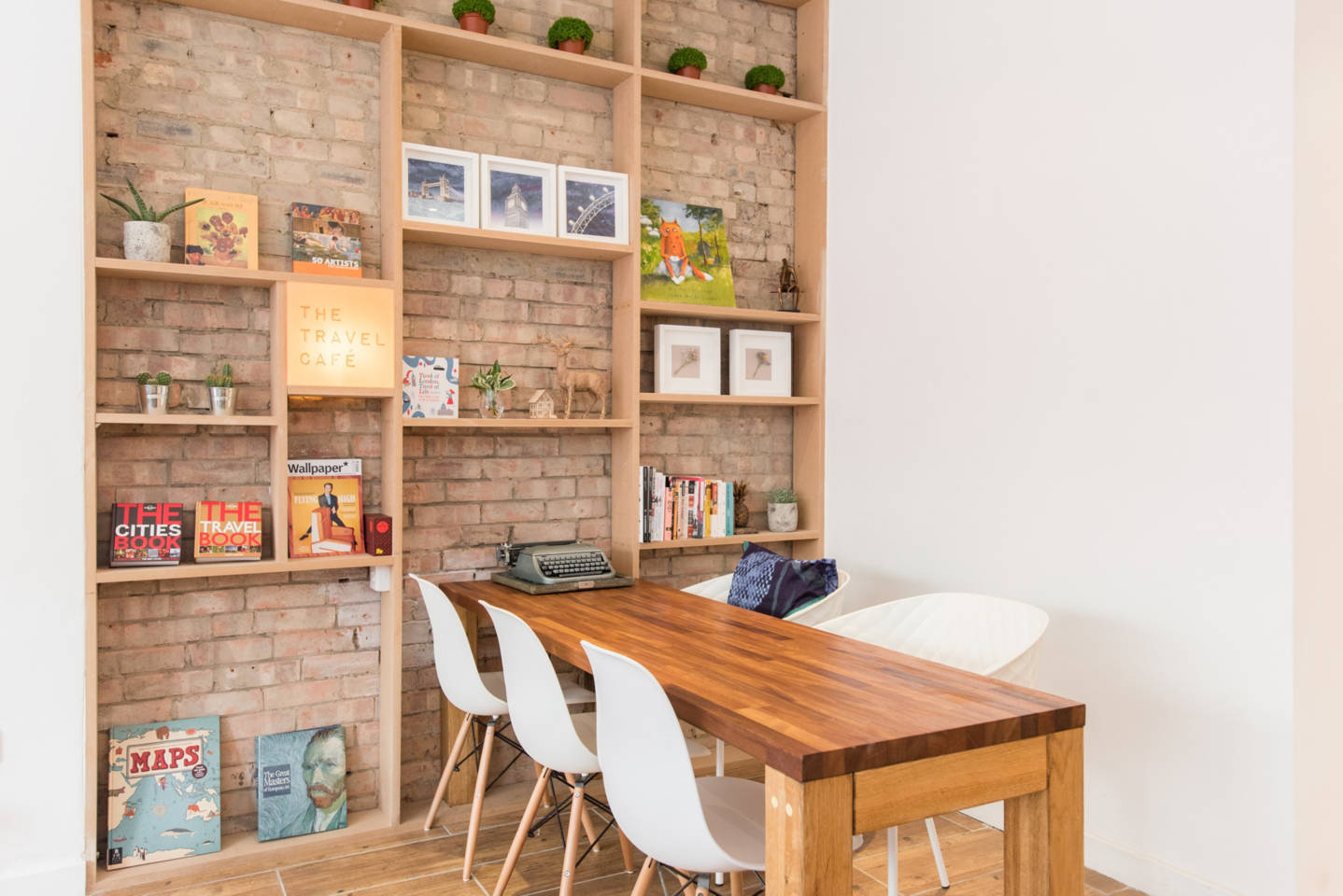 Cozy meeting room with wooden table and modern chairs at The Travel Café.