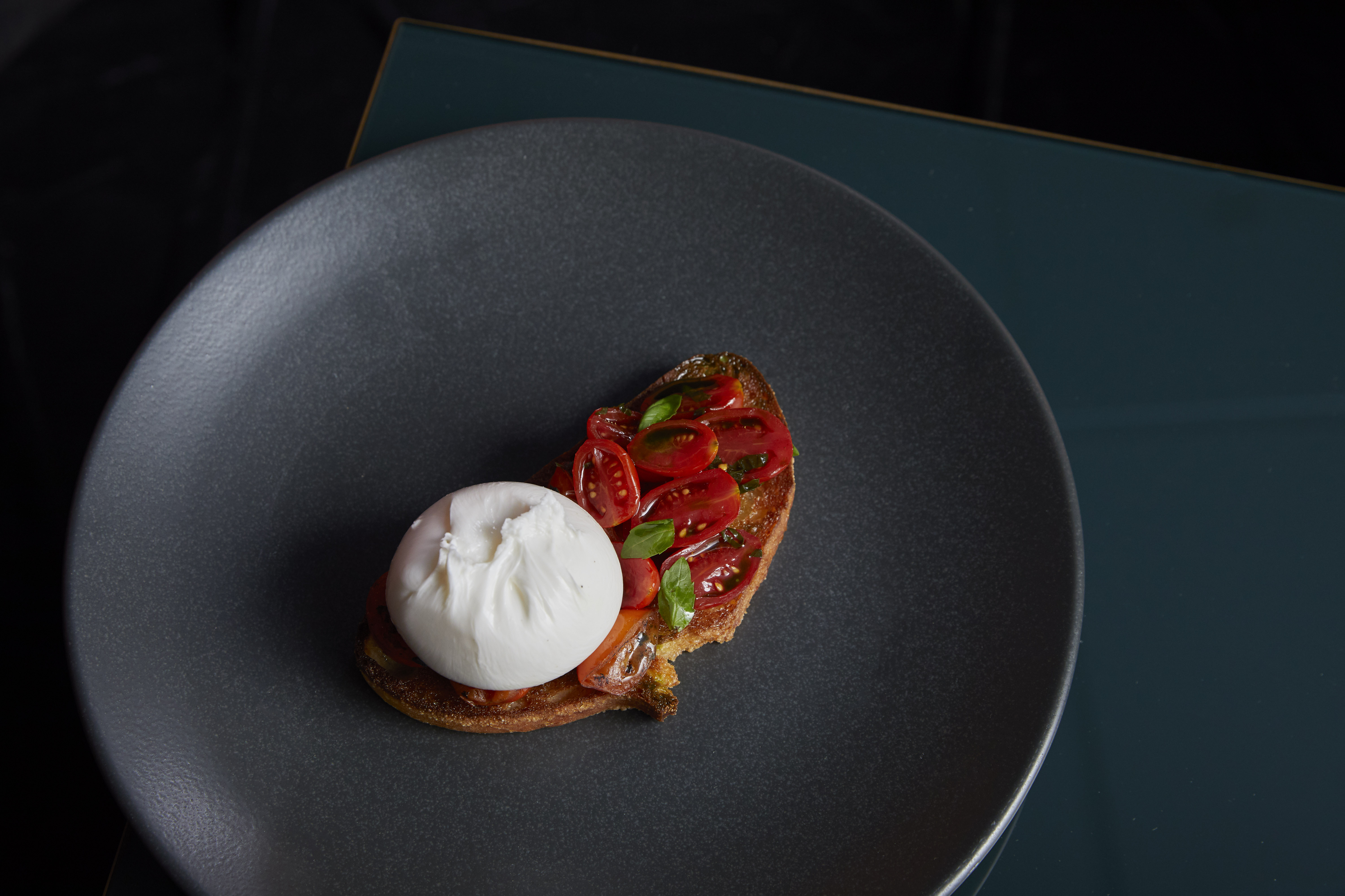 Semi-private dining room with poached egg dish, perfect for events and catering.