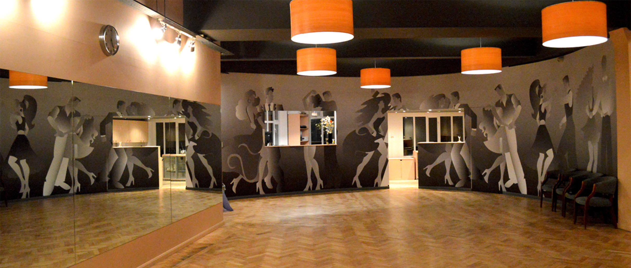 Stylish dance studio with elegant murals, ideal for classes and workshops.