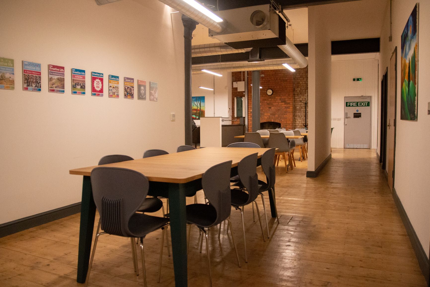 Versatile meeting space with long table and bright artwork for workshops at Swan Buildings.
