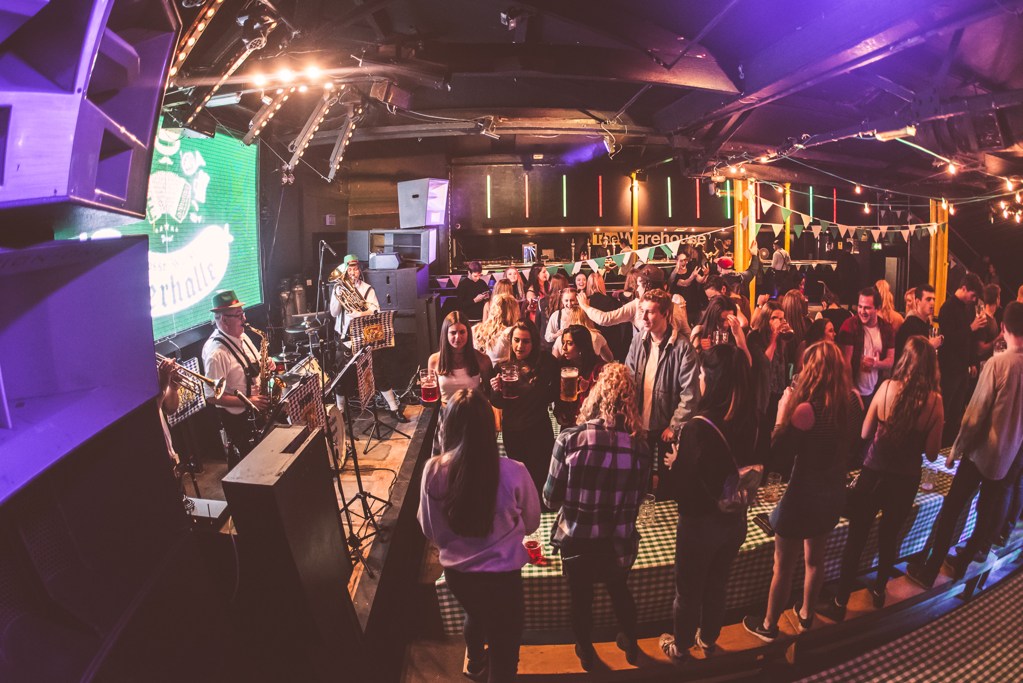 Vibrant crowd enjoying live music at Leeds Warehouse event venue.