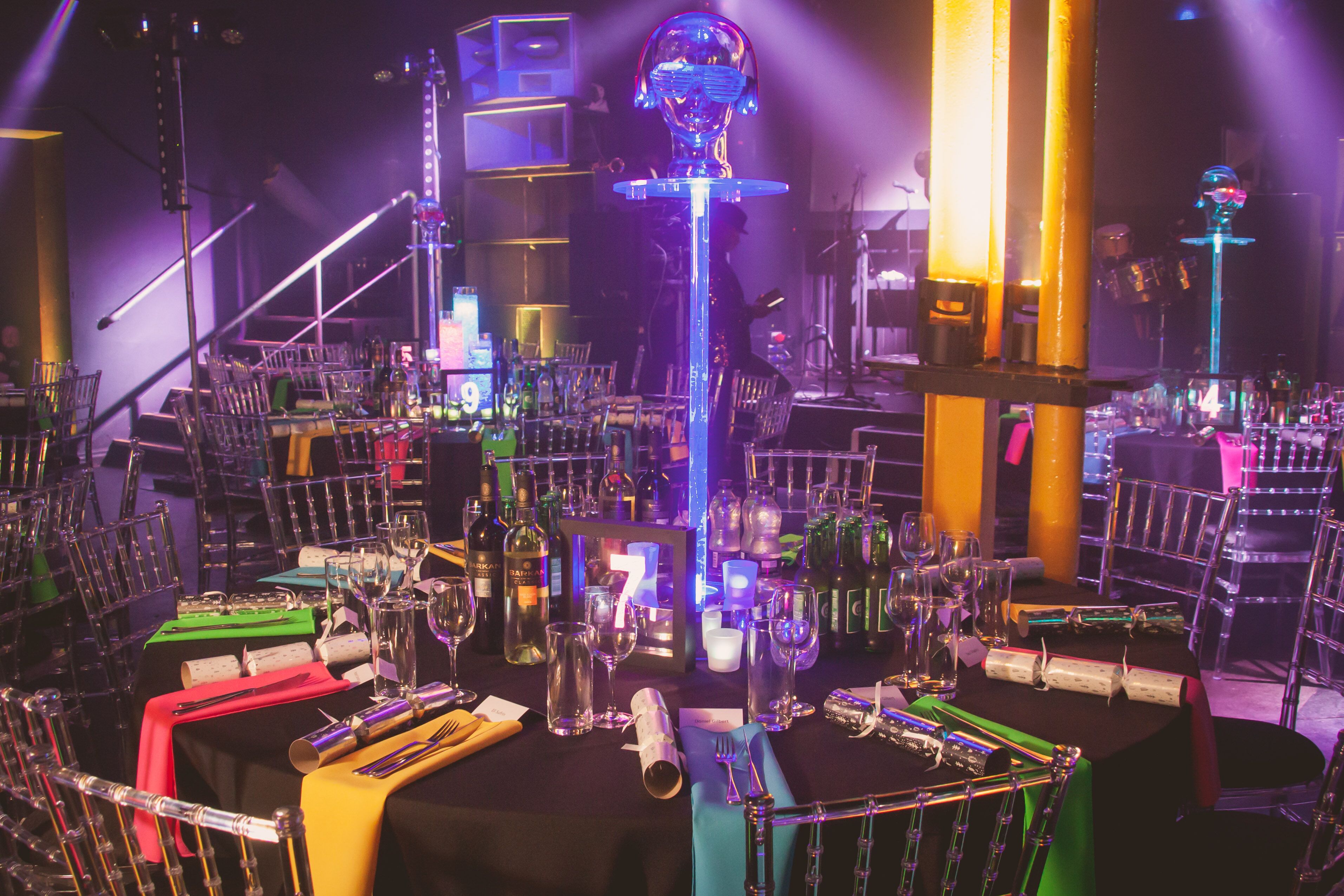 Vibrant gala setup in Leeds Warehouse with elegant tables and colorful linens.