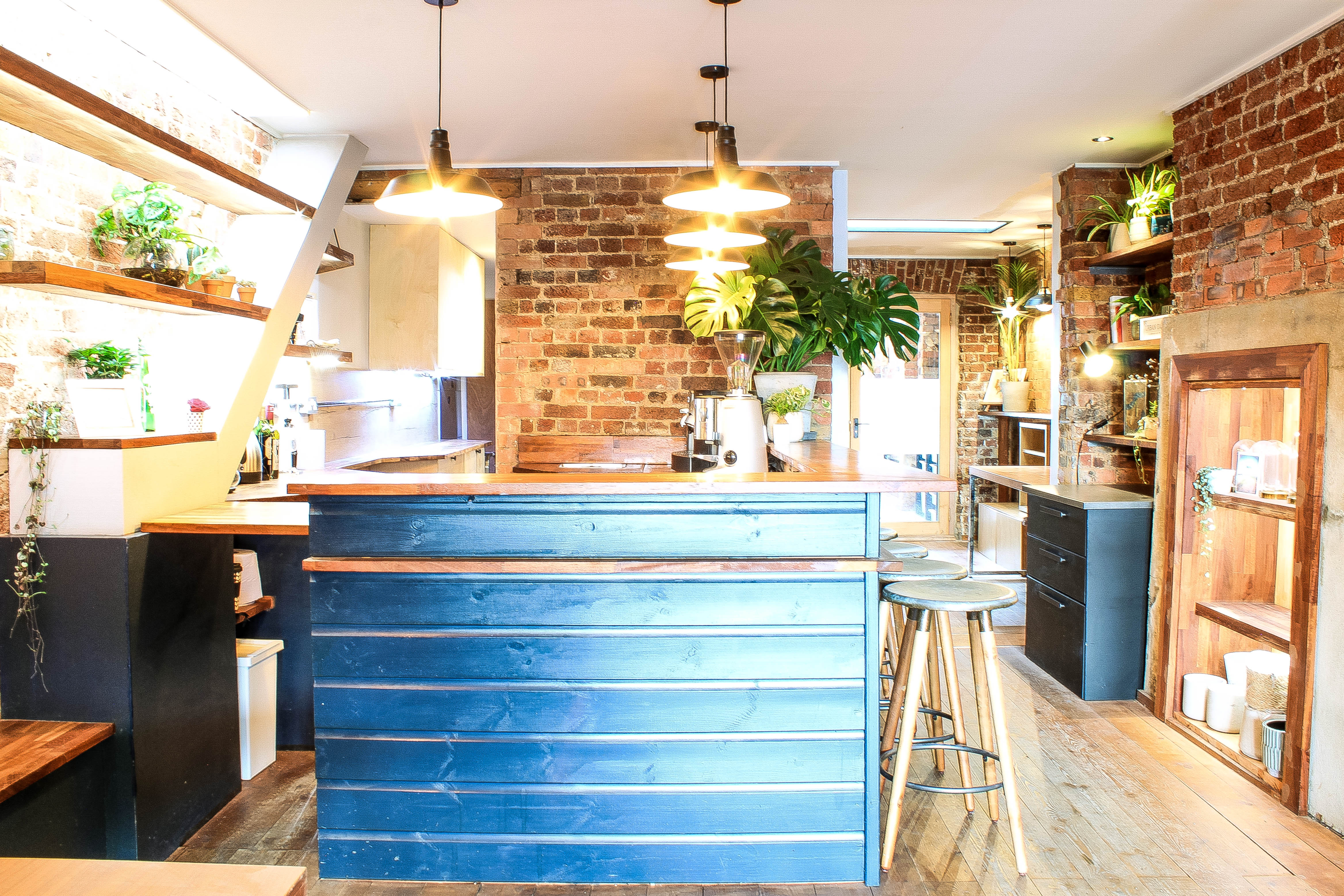 Modern event space with exposed brick, ideal for meetings and workshops at The Travel Cafe.