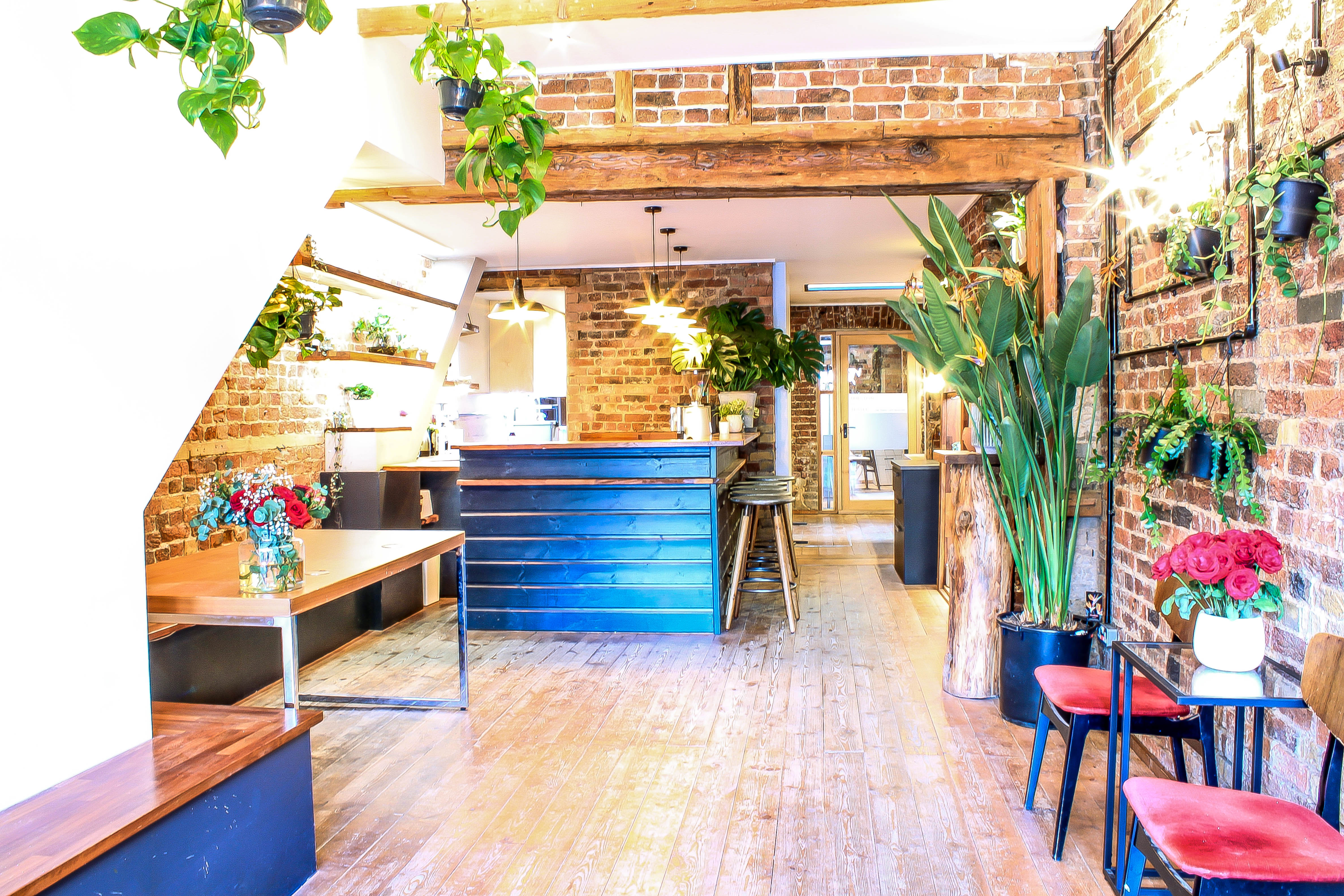 Stylish event space with exposed brick, ideal for networking and workshops at The Travel Cafe.