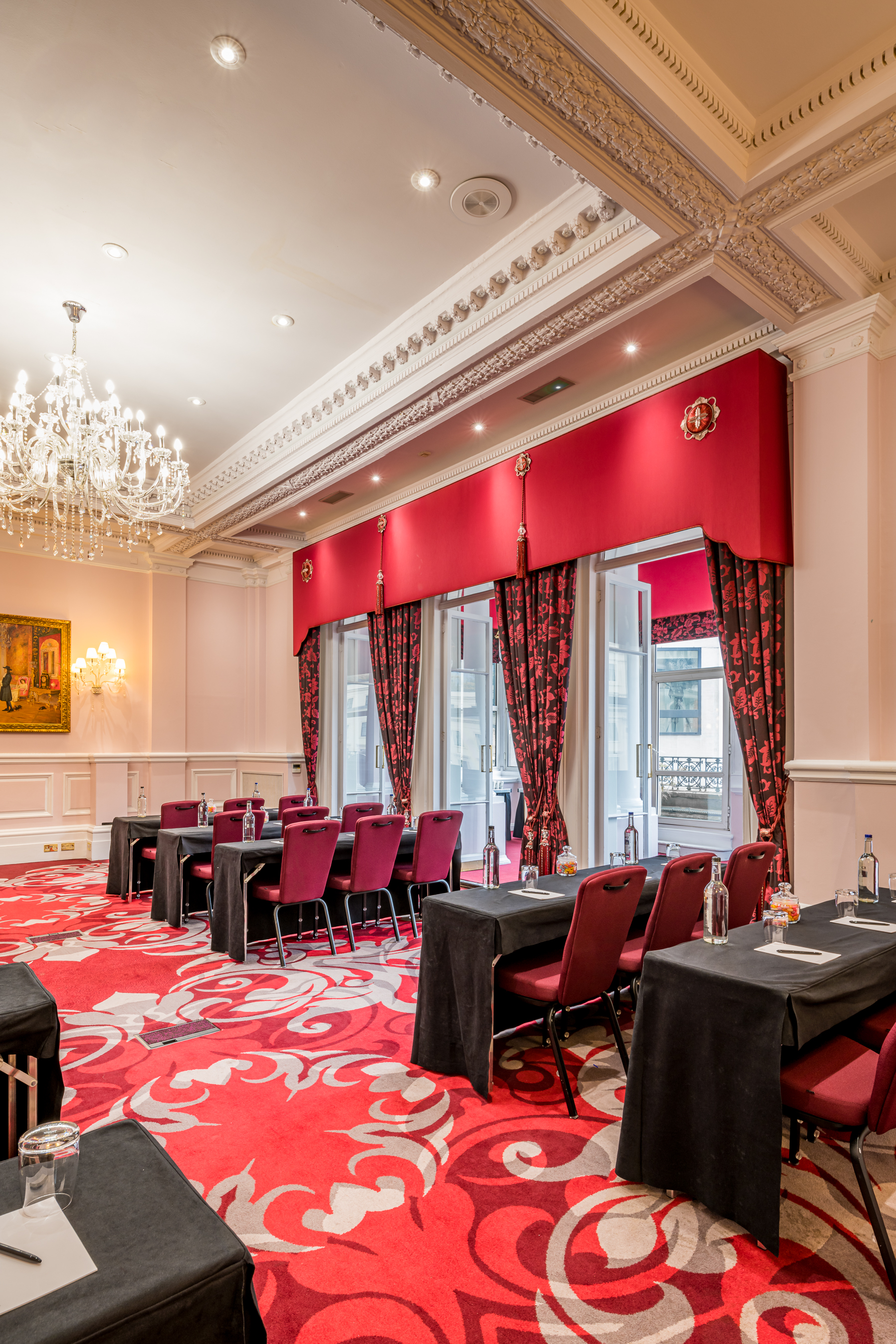 Elegant meeting room in Canterbury with red accents, perfect for workshops and presentations.