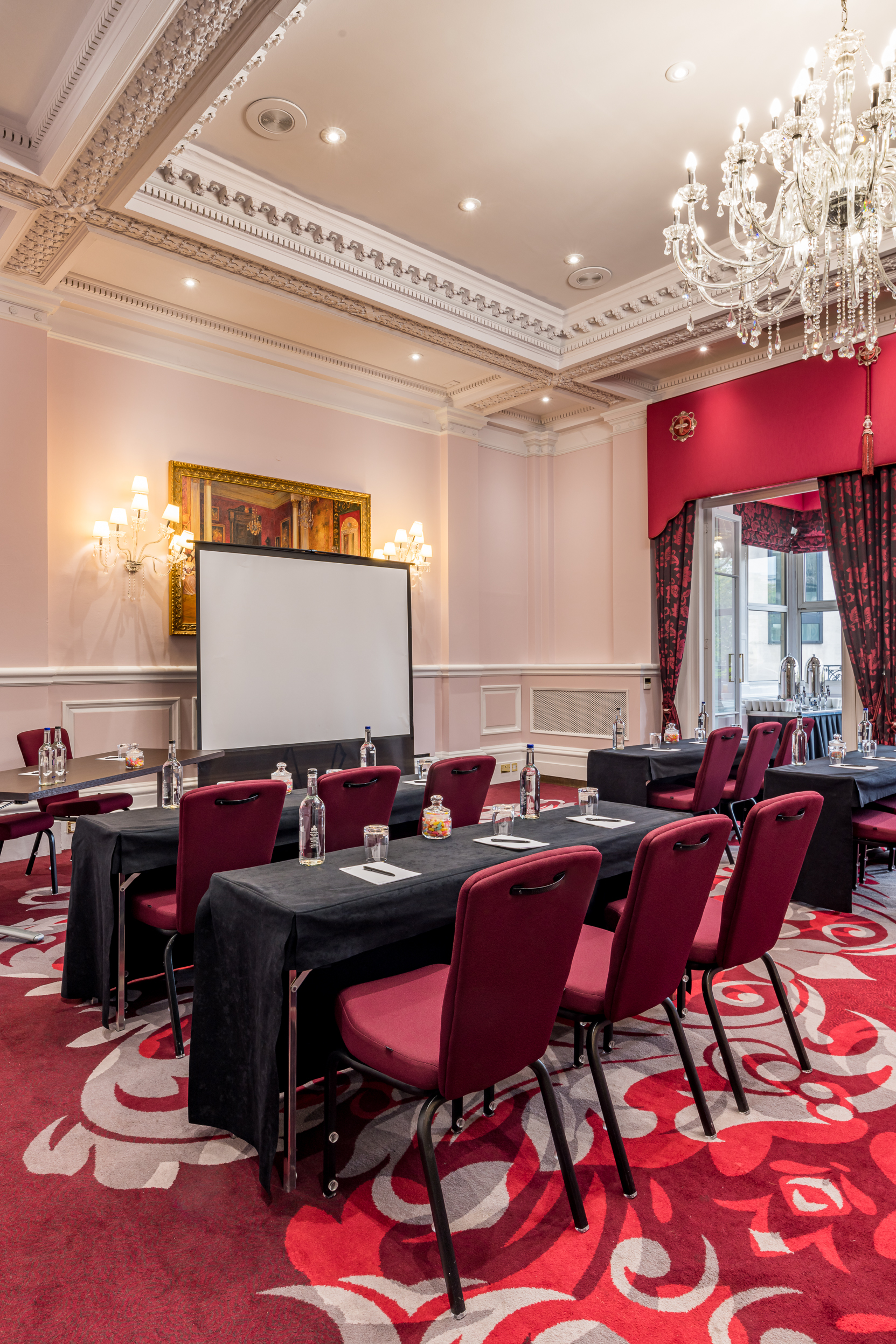 Meeting room at Clermont Charing Cross with presentation screen for corporate events.