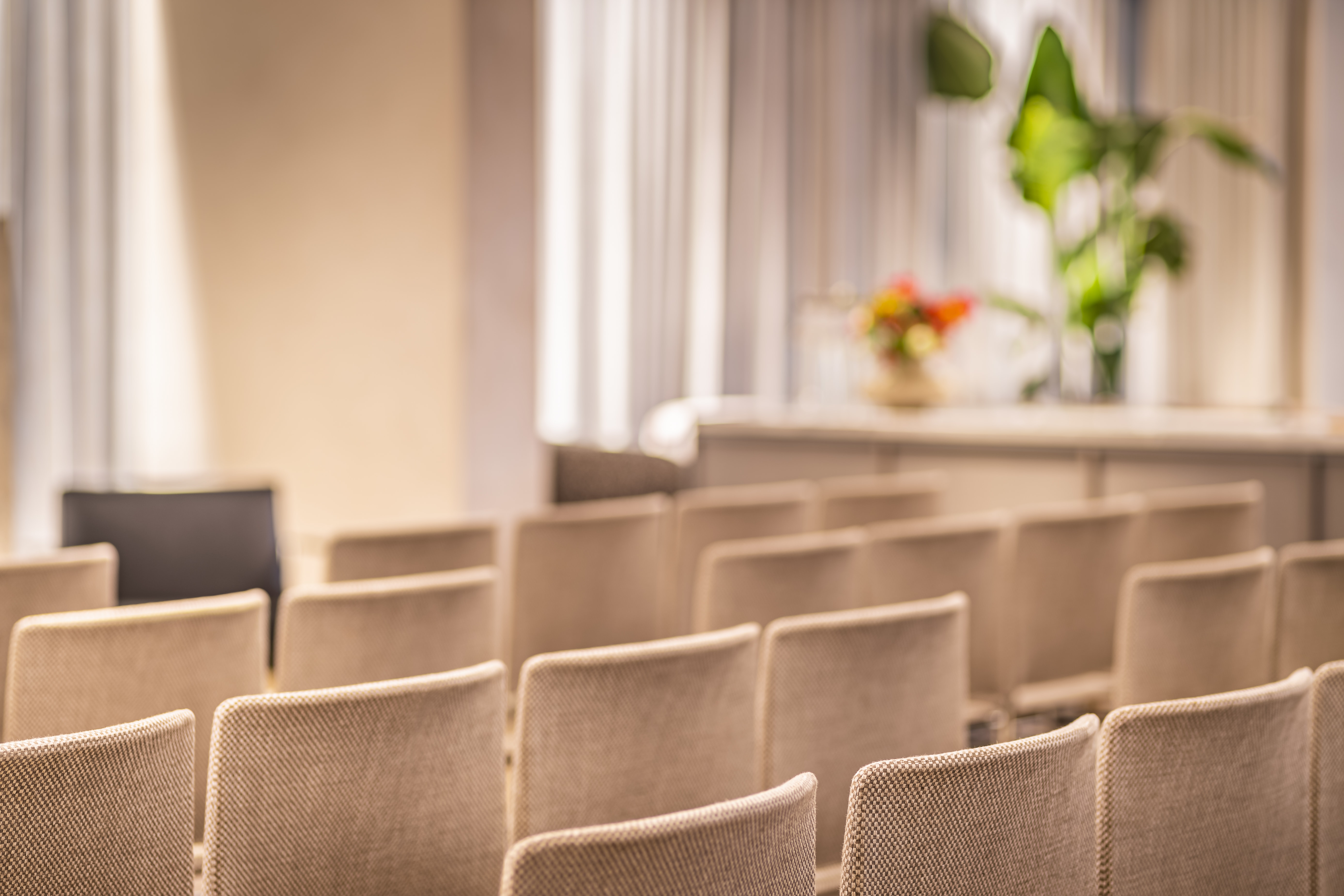Meeting space at The Mezzanine, featuring comfortable chairs and inviting decor for events.