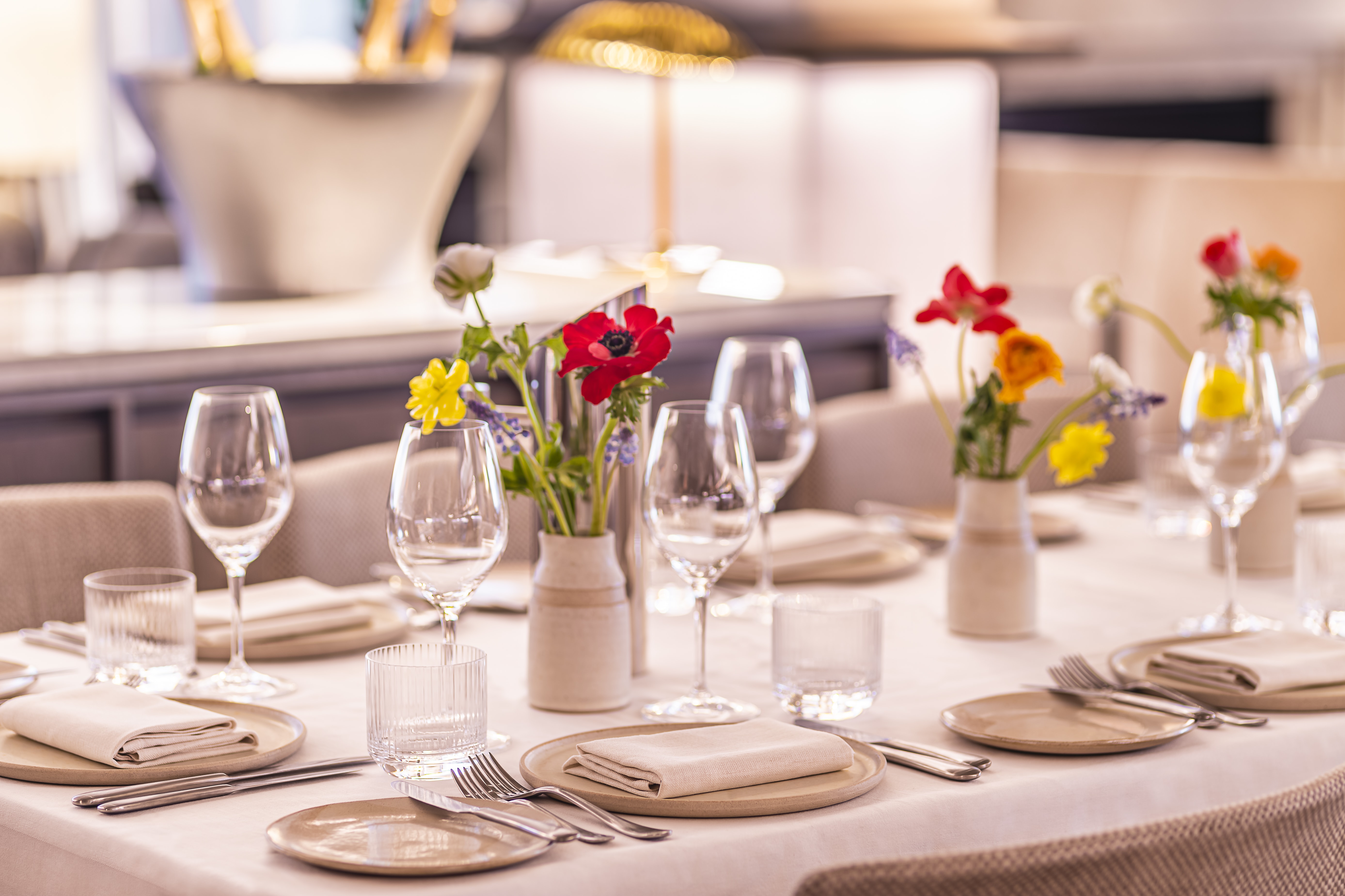 Elegant dining table with floral centerpieces for formal events at The Mezzanine.