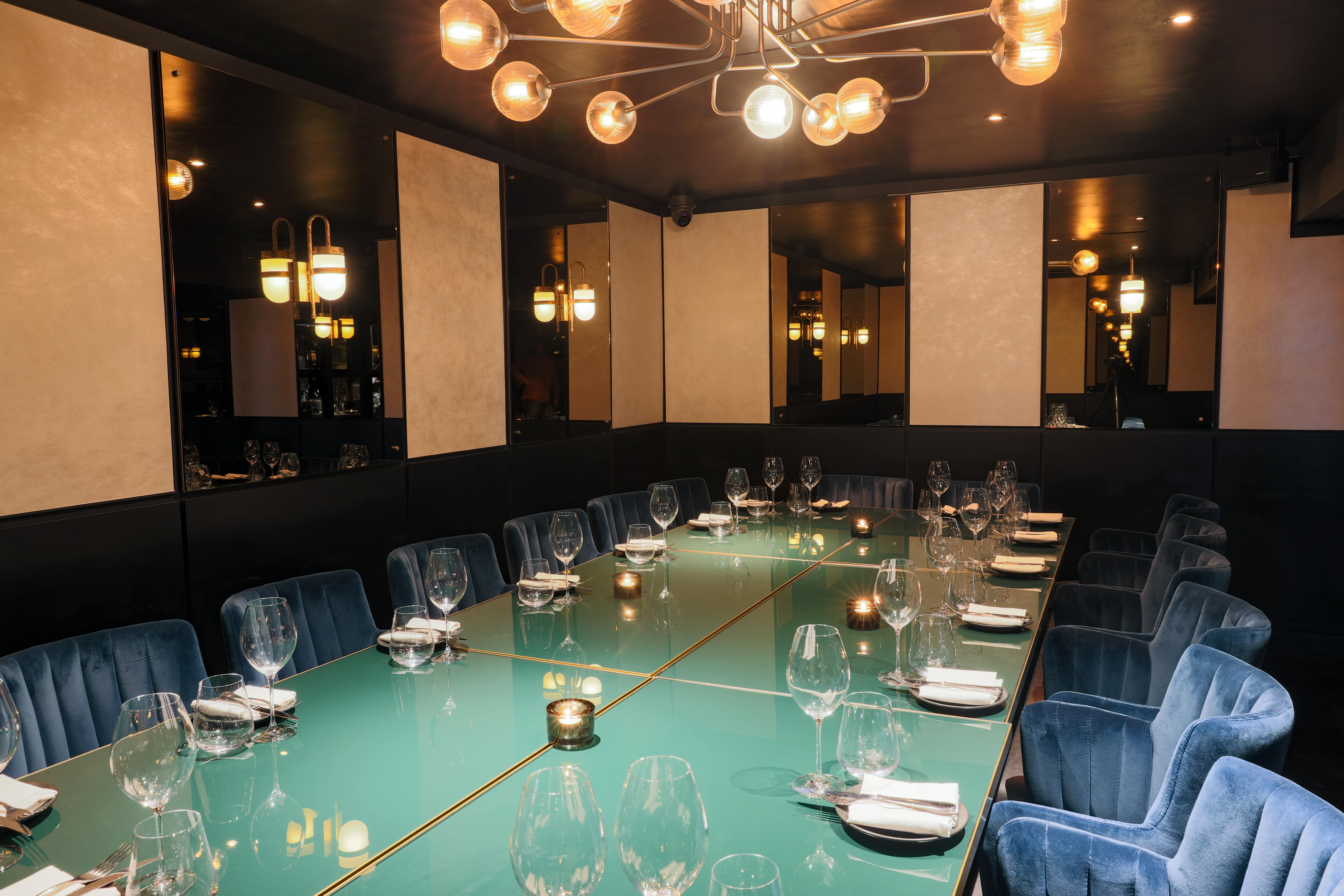 Private dining room with plush blue chairs for intimate corporate events at Gaucho Chancery Lane.
