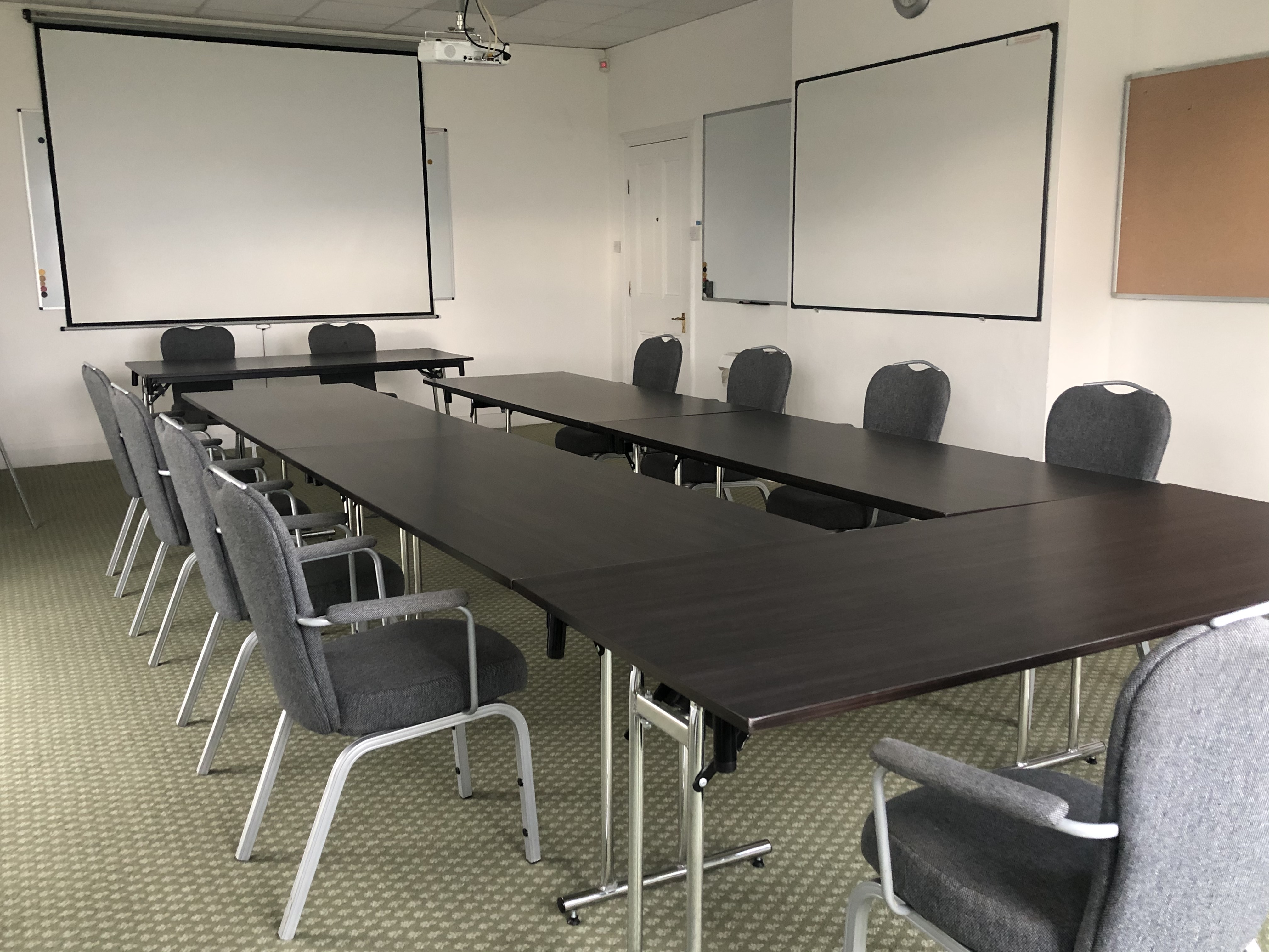 William Stokes in a collaborative meeting room with a long table, ideal for workshops.