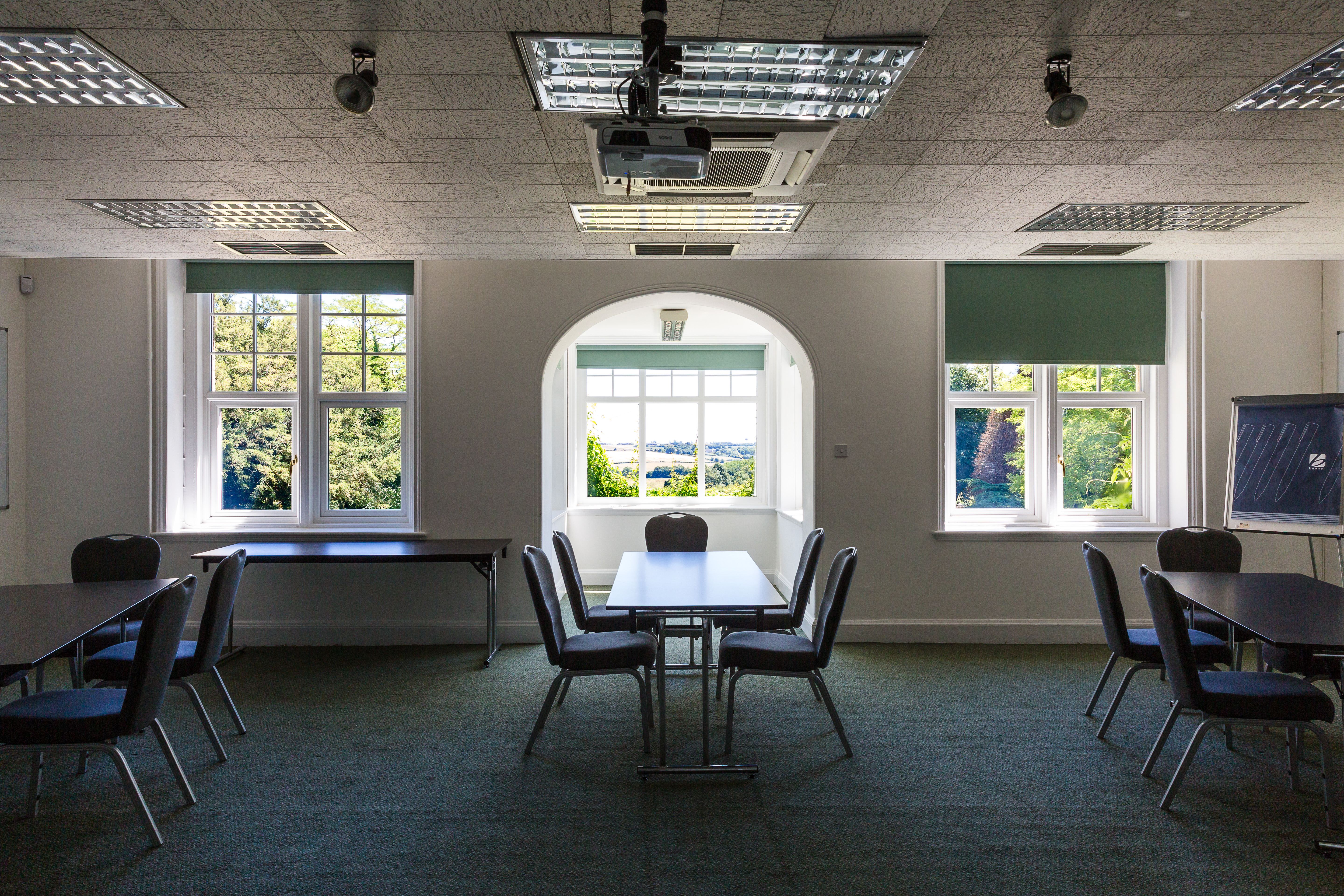 Versatile meeting space at Middle Aston House with natural light, ideal for workshops.