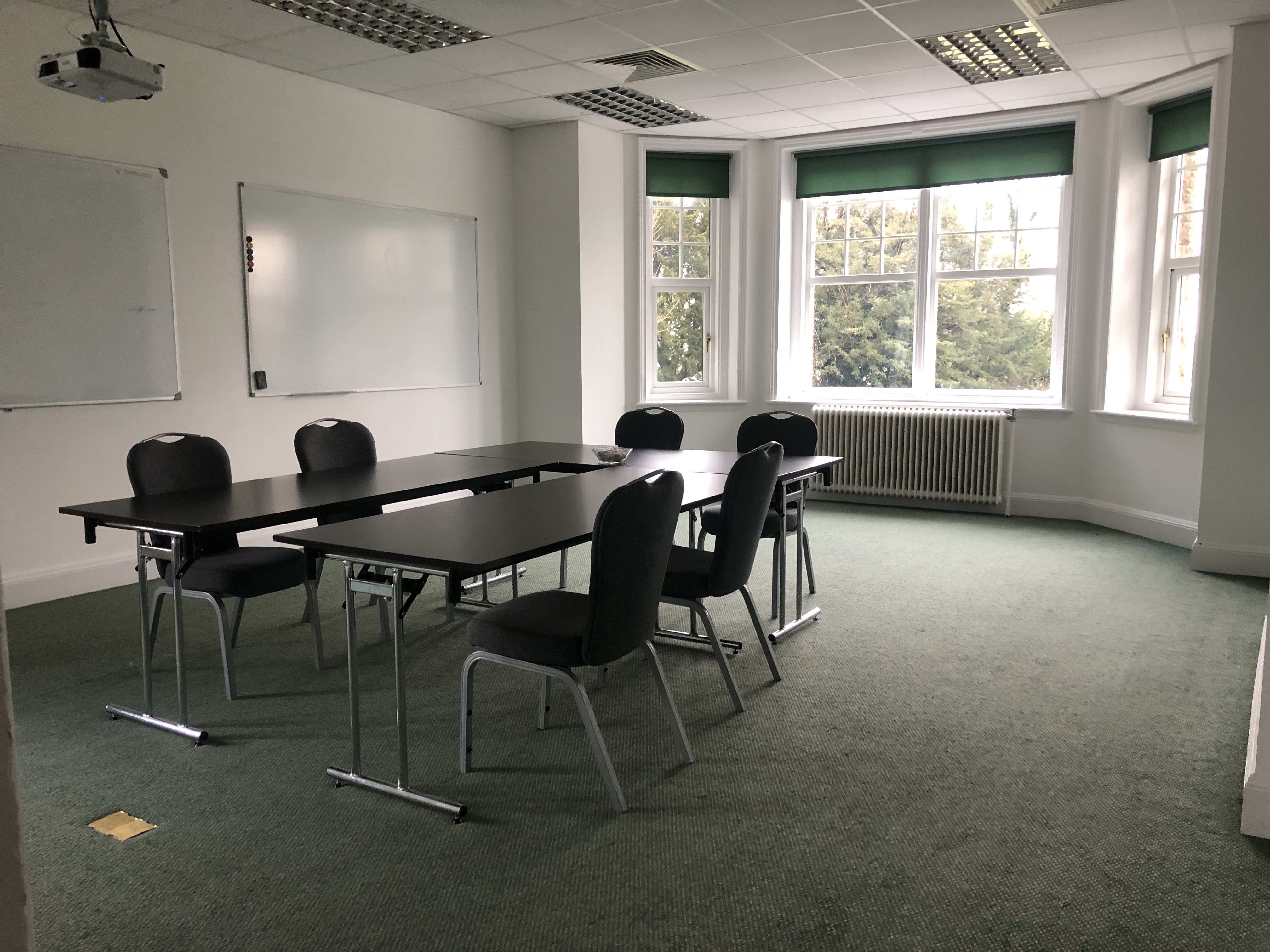 Sir John Baker in a well-lit meeting room at Middle Aston House, perfect for workshops.