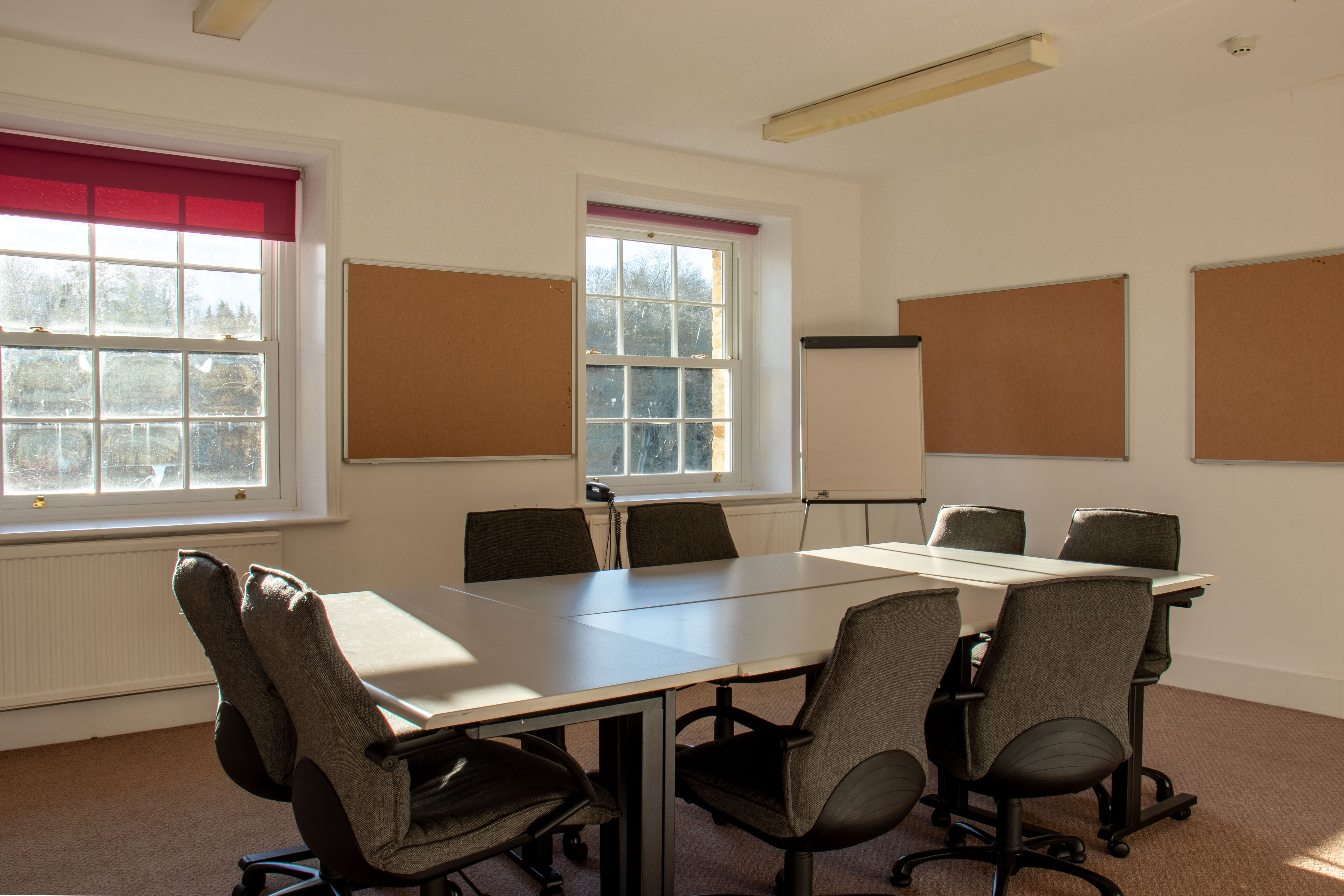 Richard Hawkins in a bright, collaborative meeting room with ergonomic chairs for workshops.