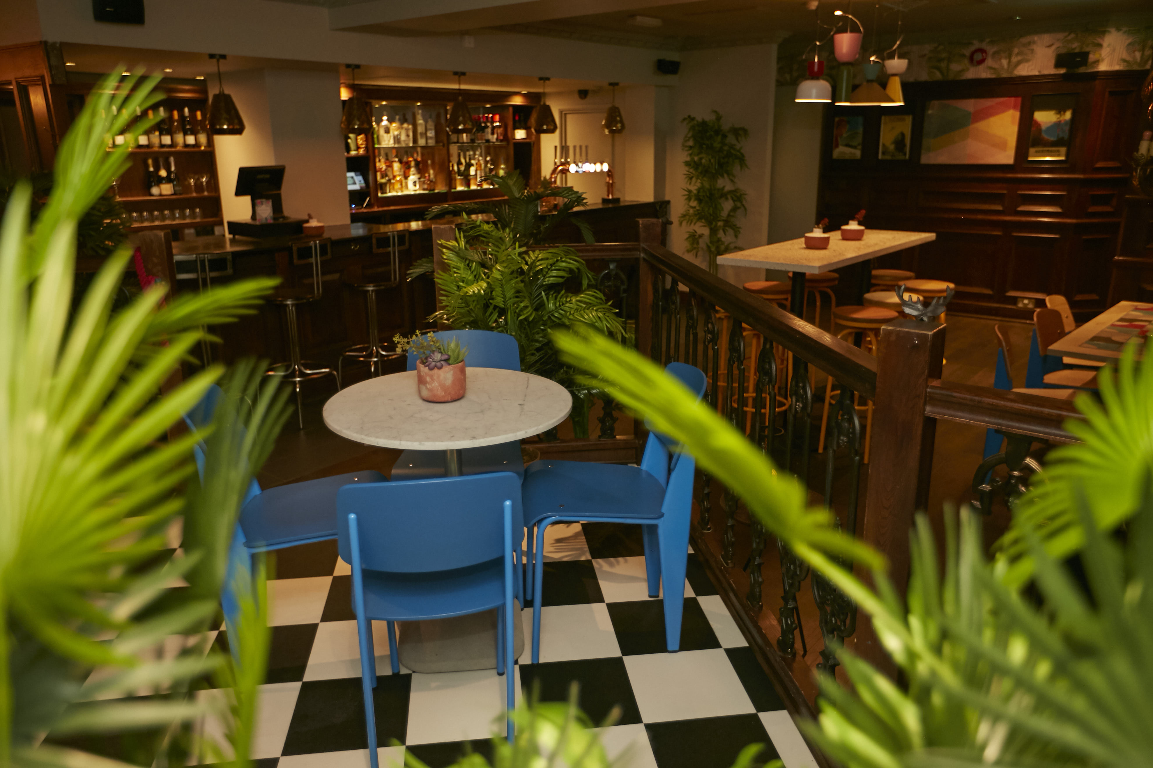 Cozy bar and restaurant with blue chairs, perfect for networking events in Chancery.