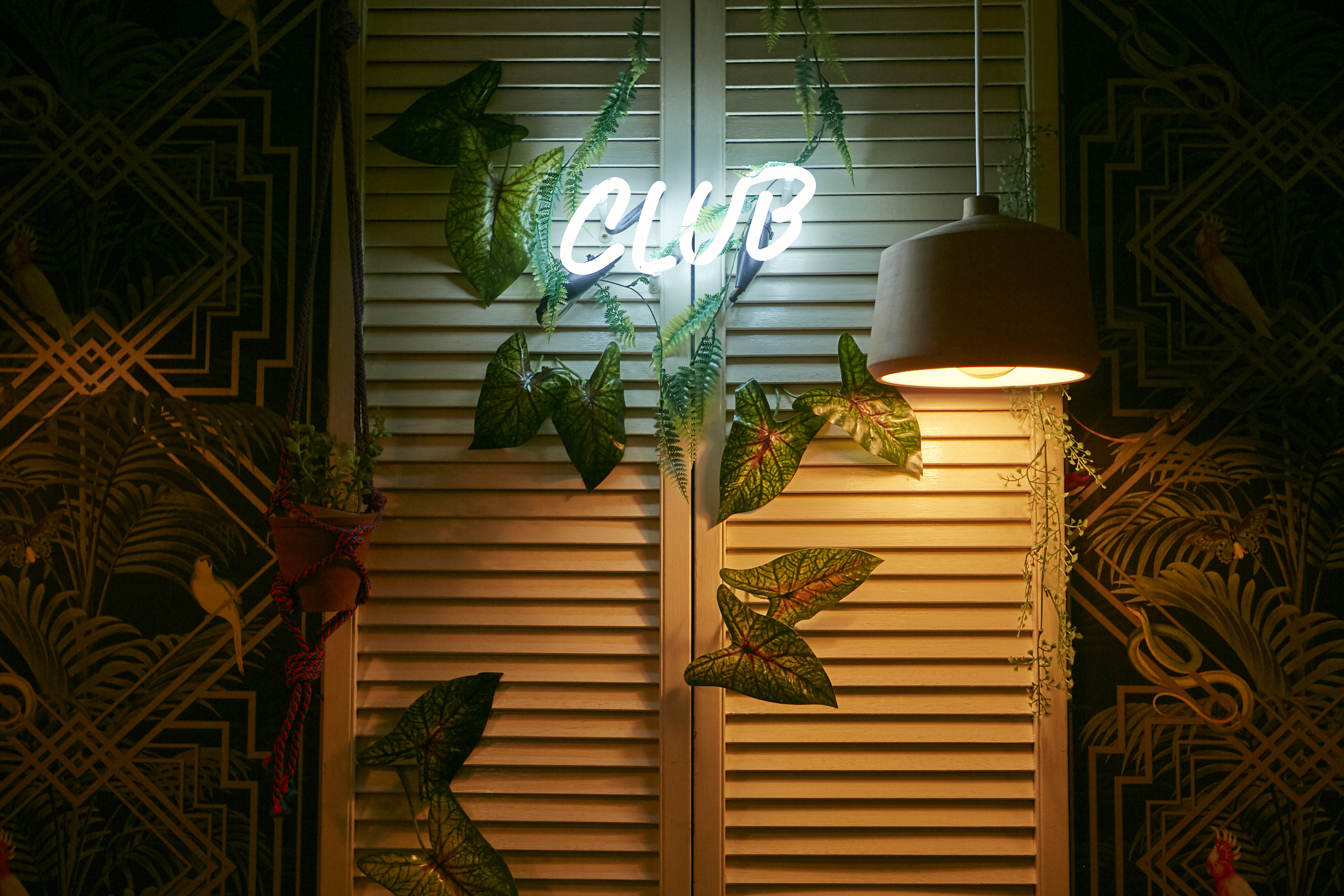 Stylish bar with neon "CLUB" sign, perfect for social gatherings and themed parties.