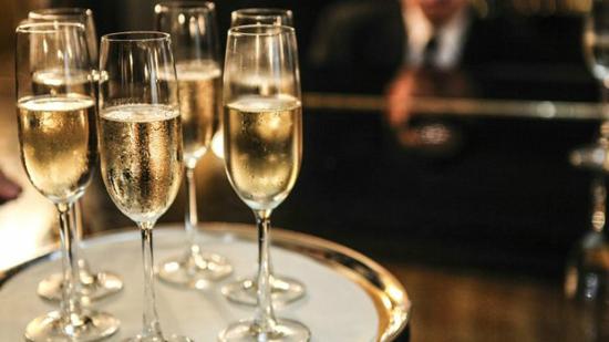 Elegant champagne flutes on a tray at Be At One Clapham Common for upscale events.