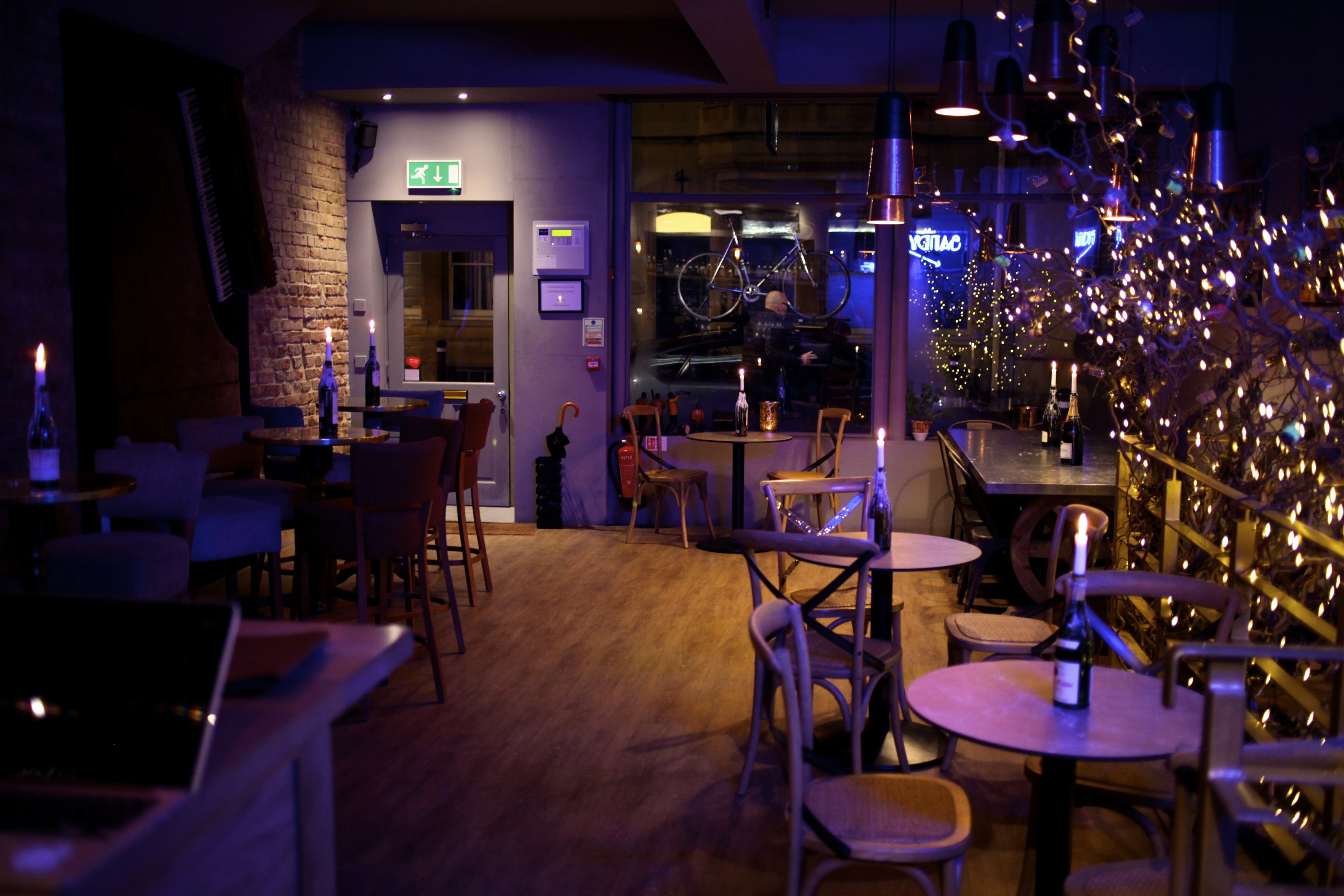 Intimate basement venue with warm lighting for gatherings and events at Sandy's Piano Bar.