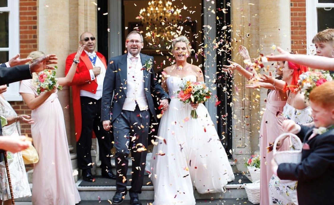 Joyful wedding celebration at Terrace Marquee, Hunton Park Hotel with confetti shower.