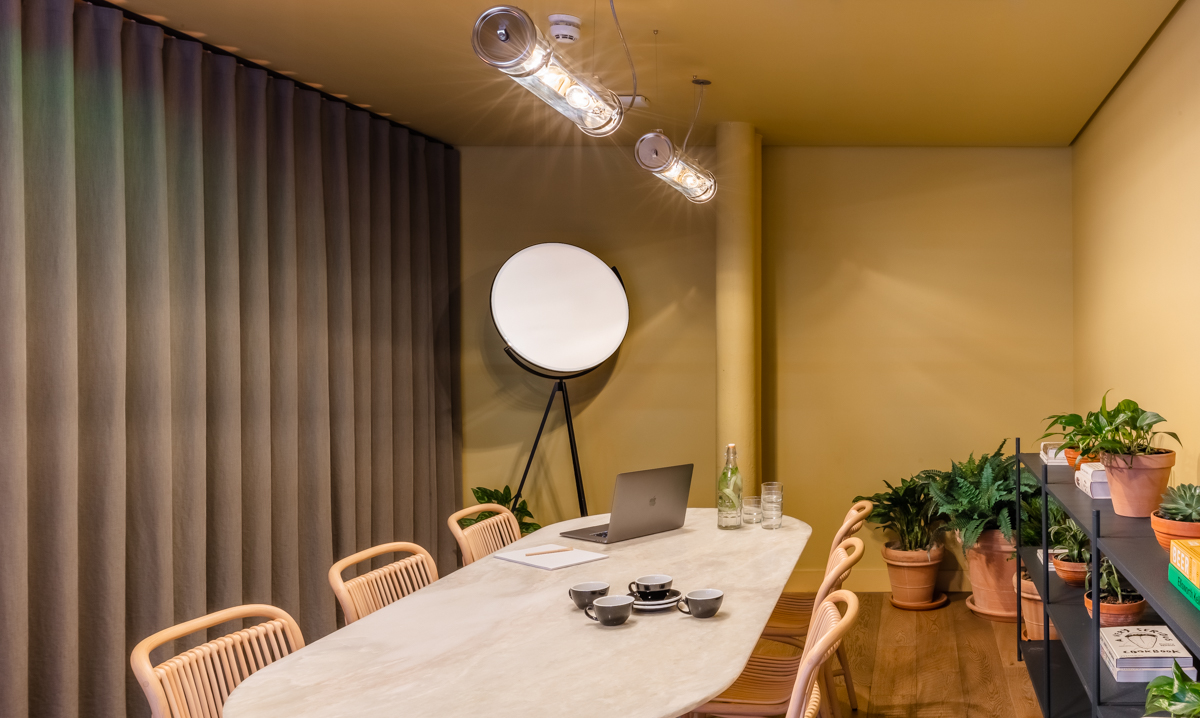 Modern meeting room with sleek table, ideal for intimate gatherings and brainstorming sessions.